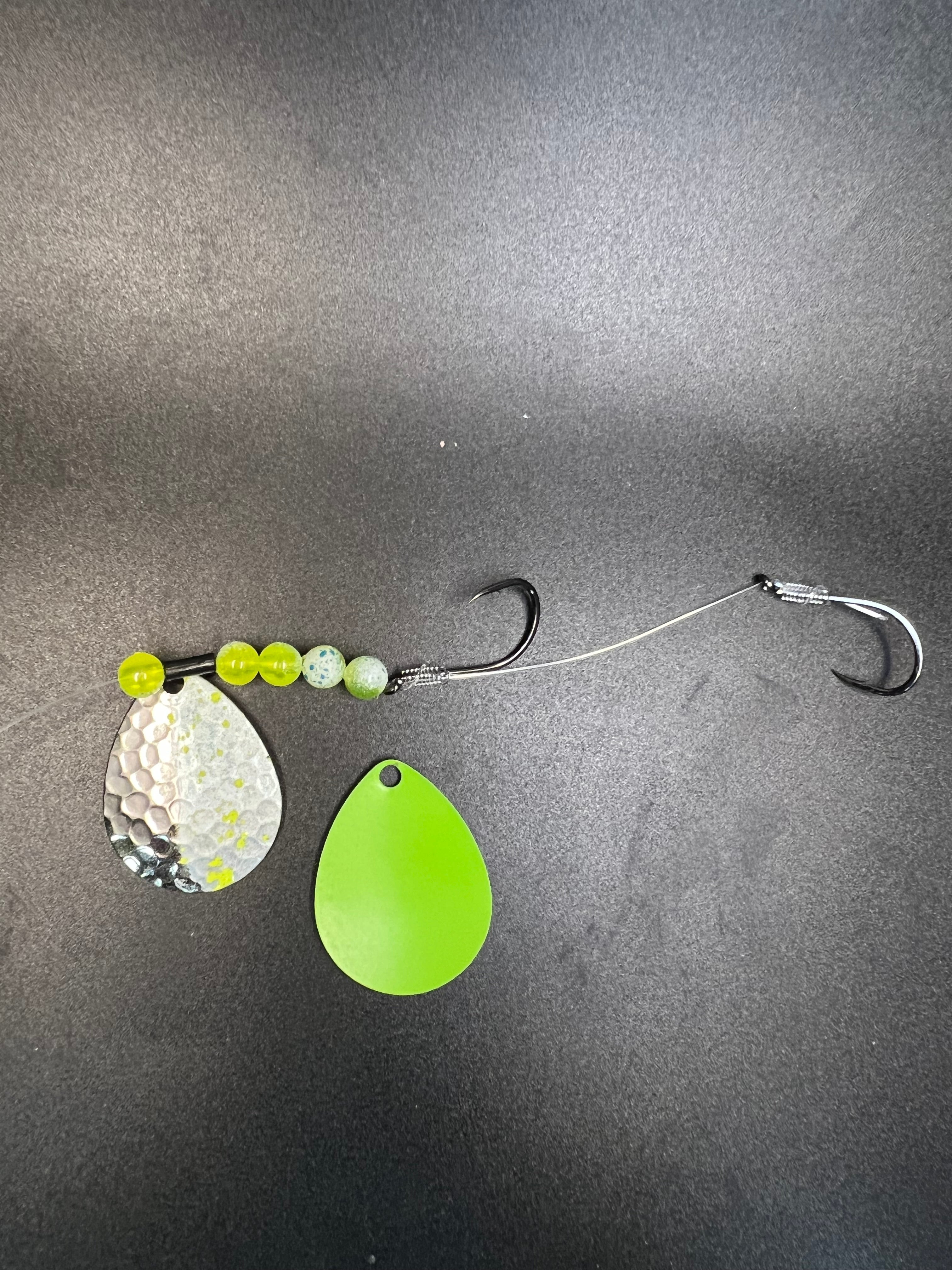 Fishing crawler harness with green teardrop spinner blade, beads, and two hooks