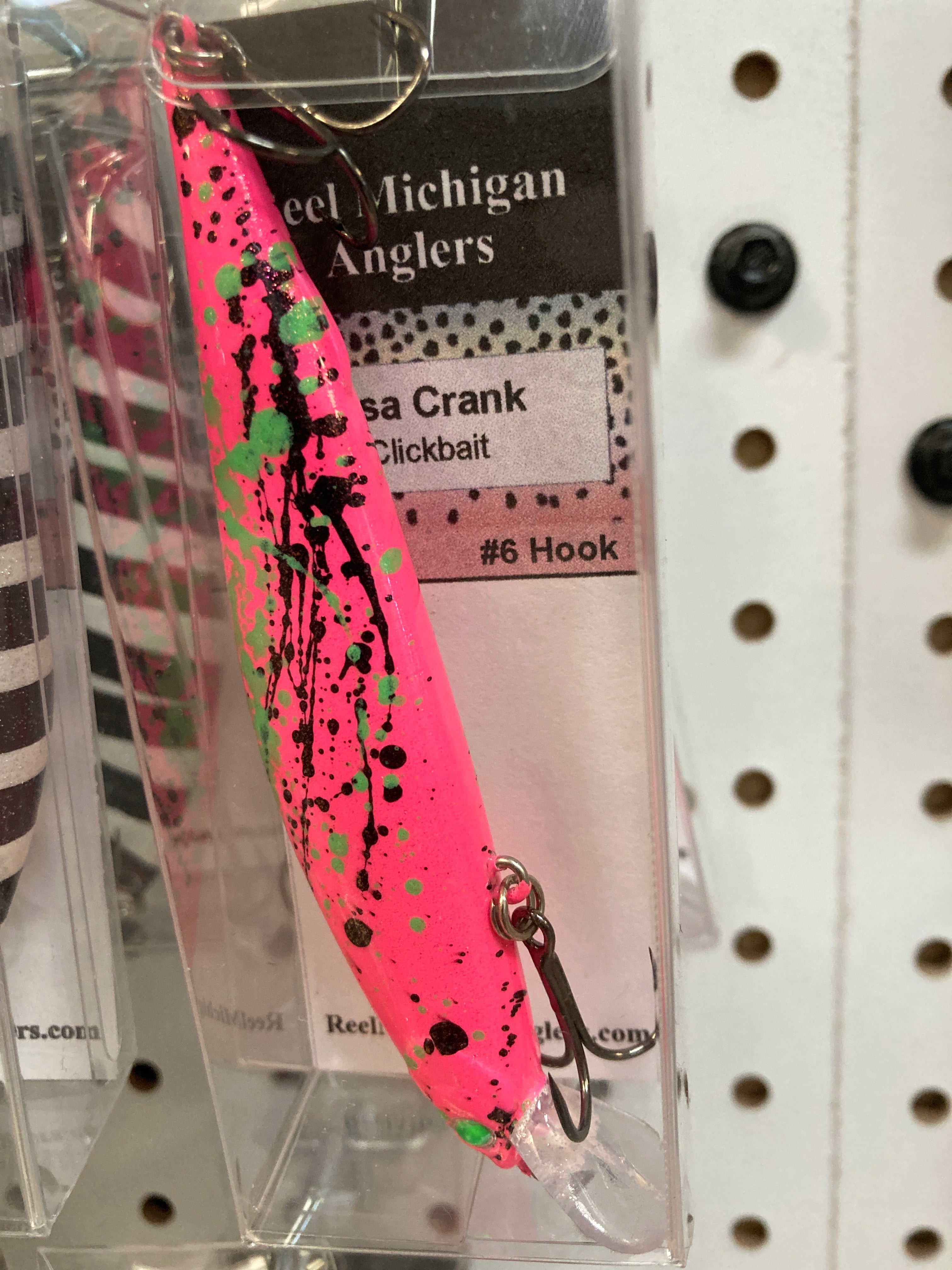 Pink fishing lure with black splatter, treble hooks, 4.25 in.