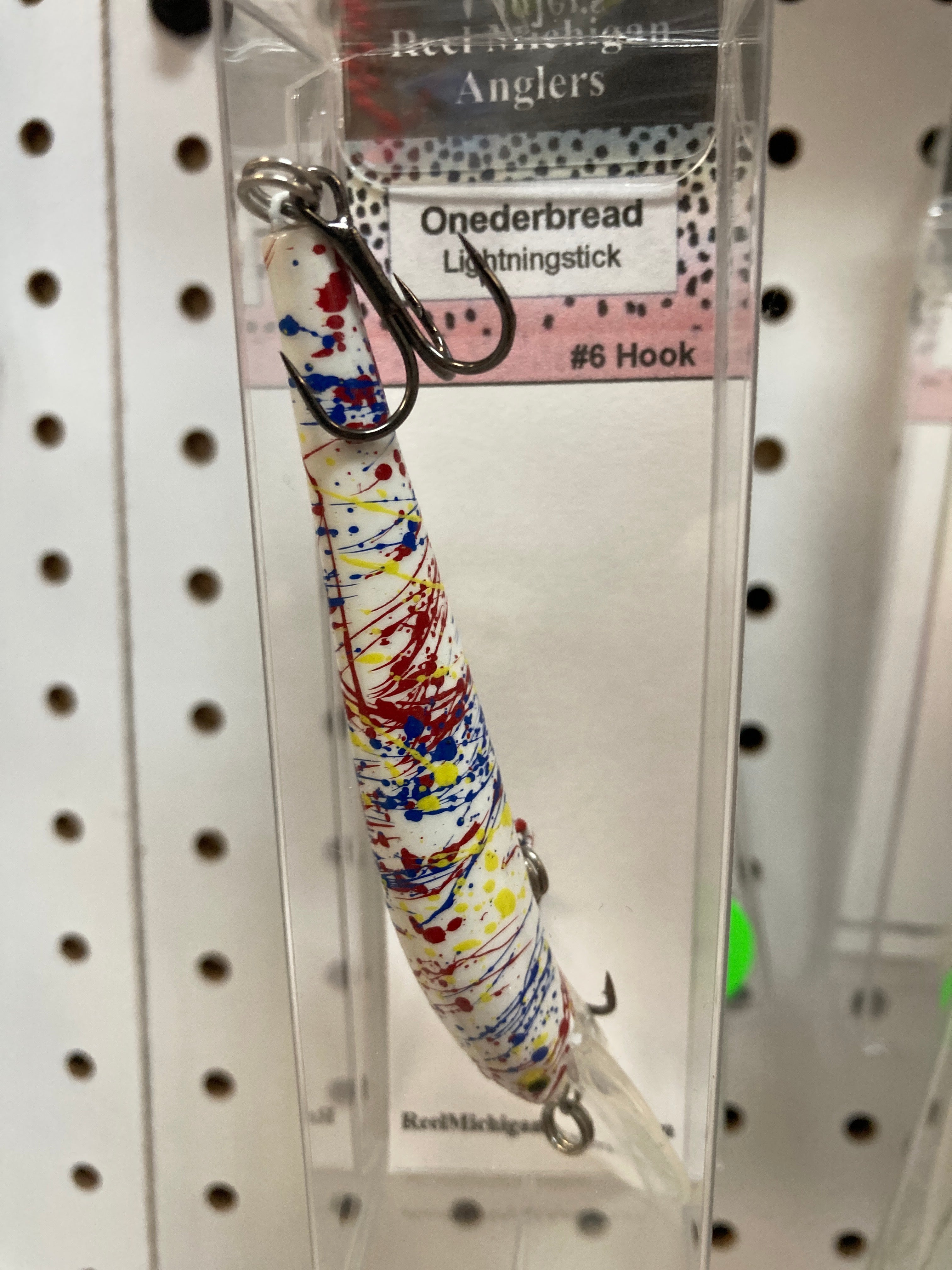 Multicolor speckled fishing lure with #6 hook and two treble hooks.