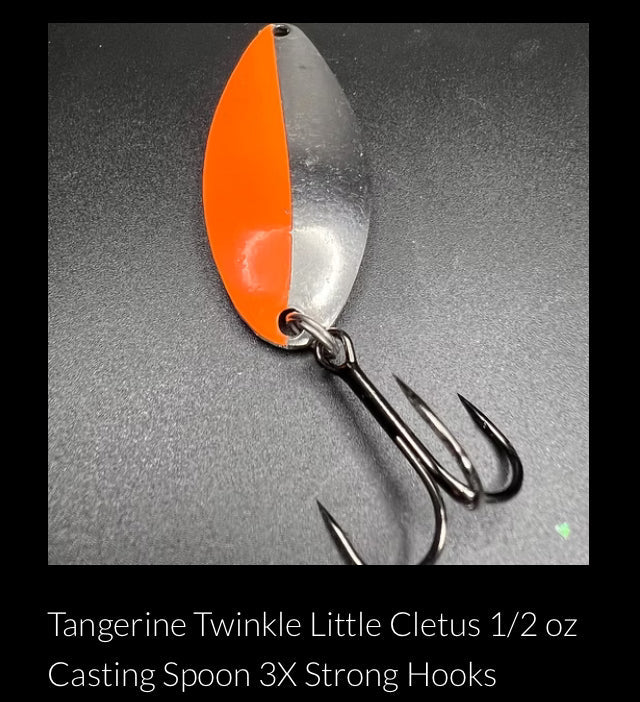 Orange casting spoon with silver back and three treble hooks