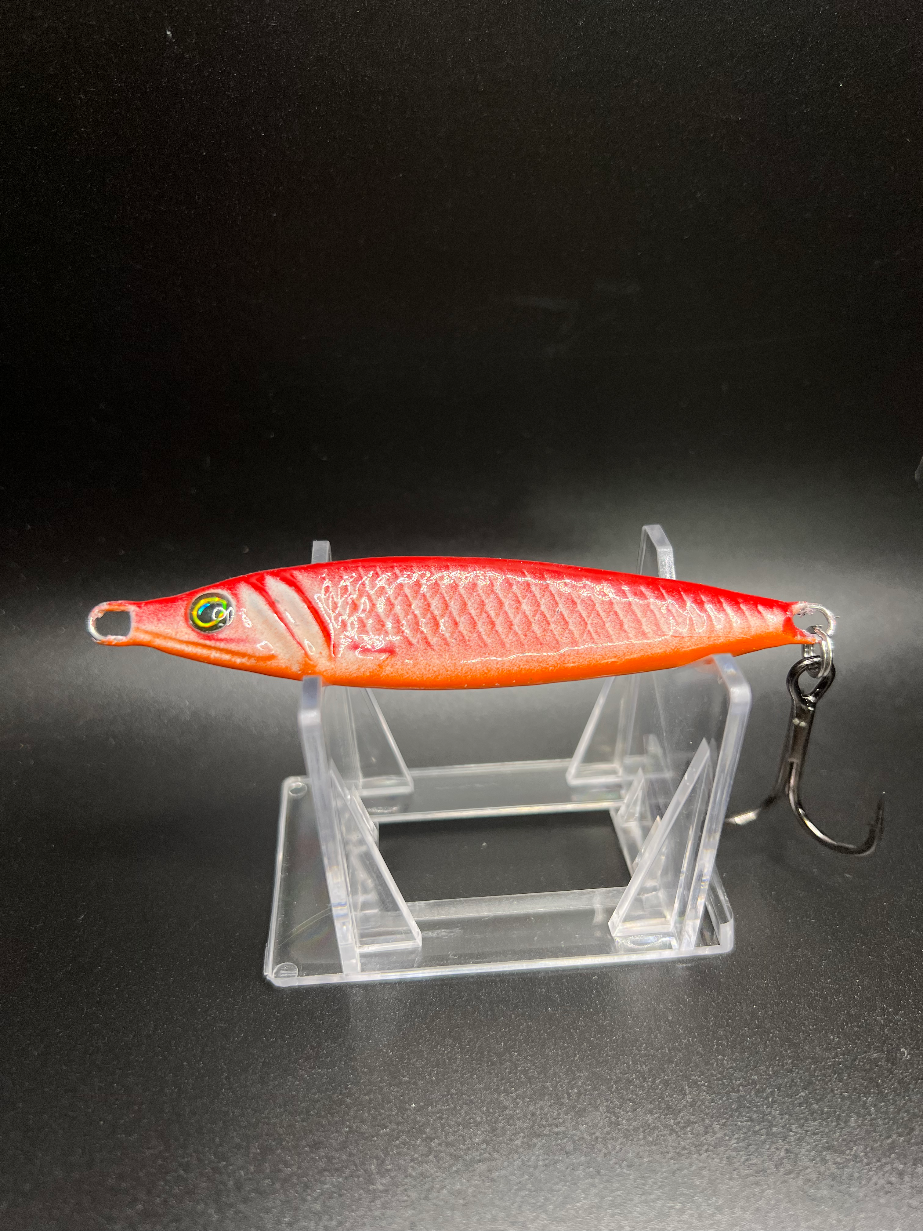 Van Whalen UV jigging spoon 2 oz, red-orange scale pattern, with treble hook