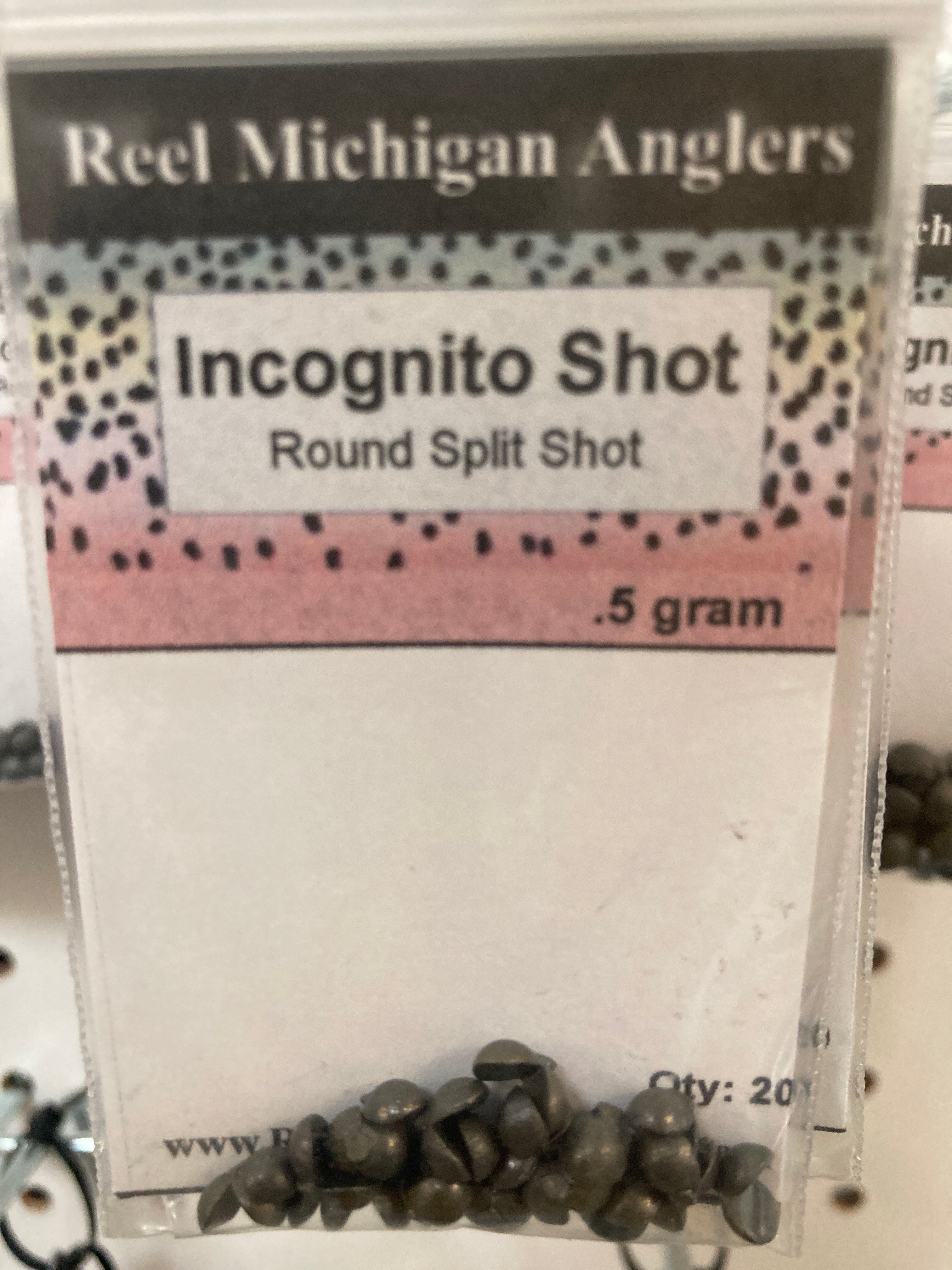 Fishing split shot sinkers, dark gray round shot pack labeled 0.5 gram