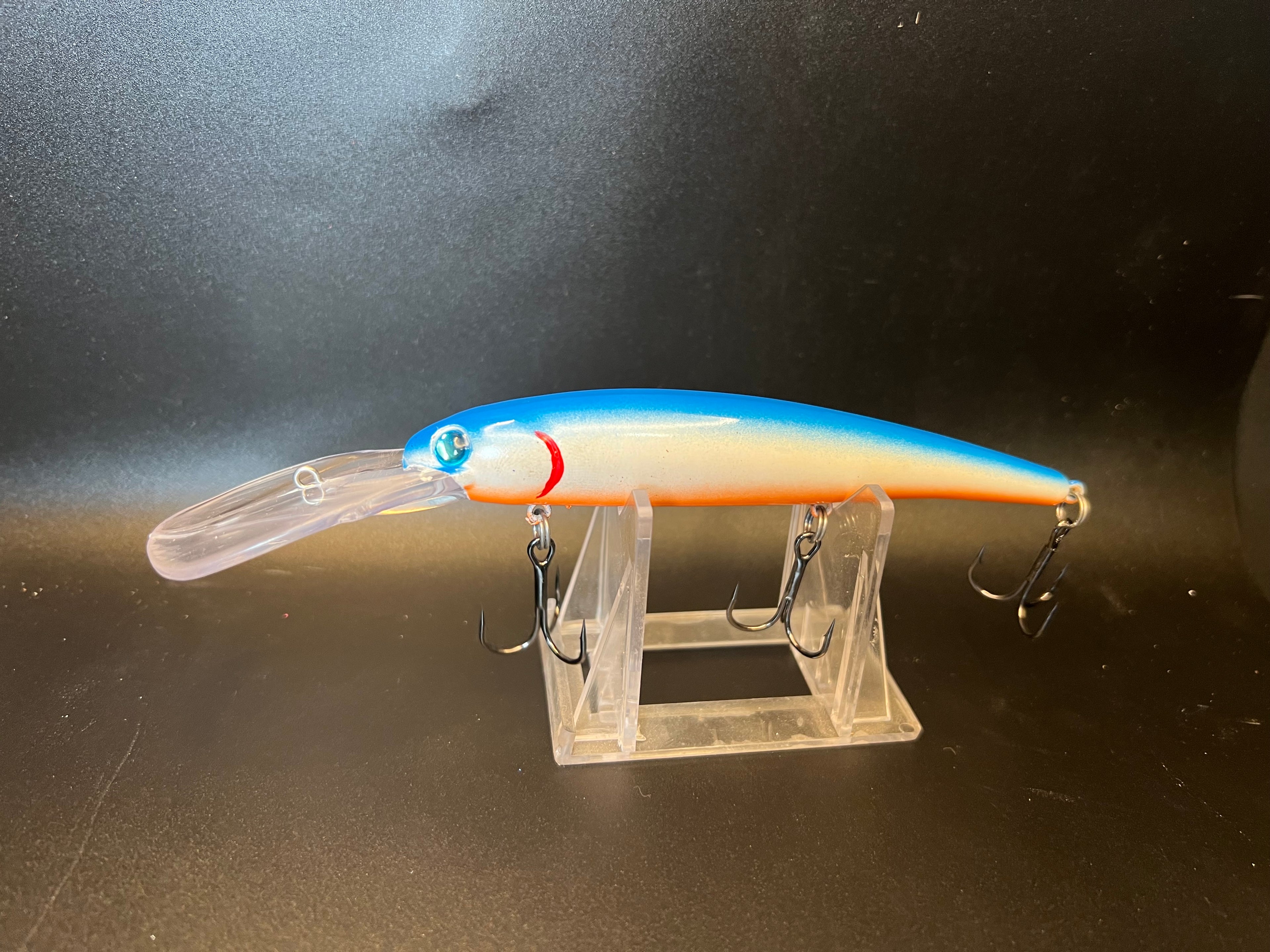Blue citrus walleye trolling lure, orange body with blue head and three trebles