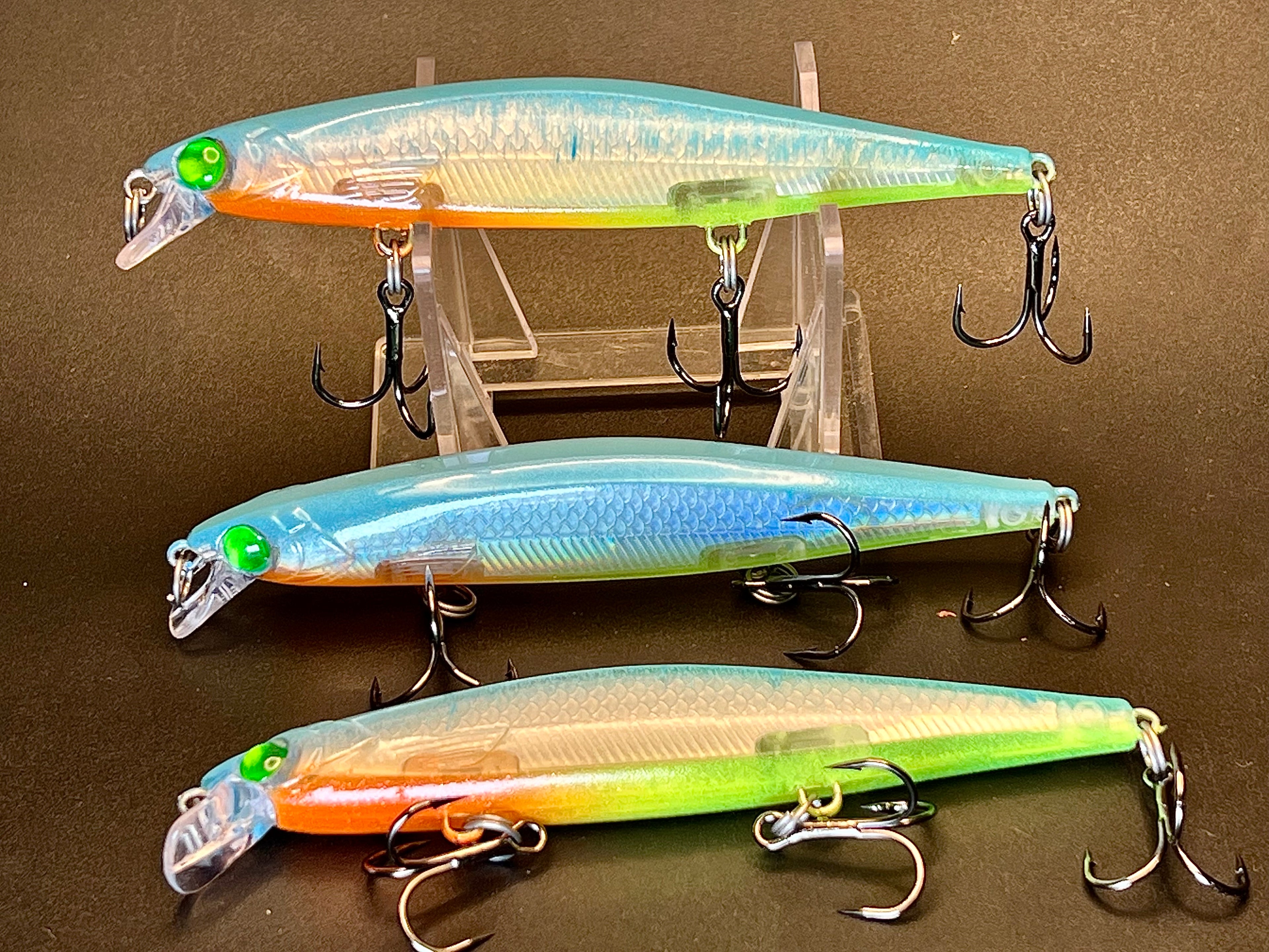Suspending jerkbait lures, 3-pack: teal, blue-silver, and orange-green bodies