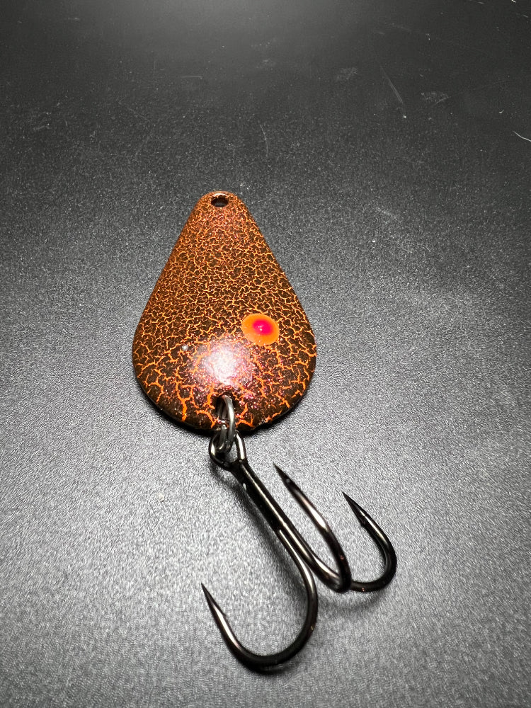 Rust Bucket TJ Bobbler: rust-orange teardrop lure with glowing eye and treble hooks