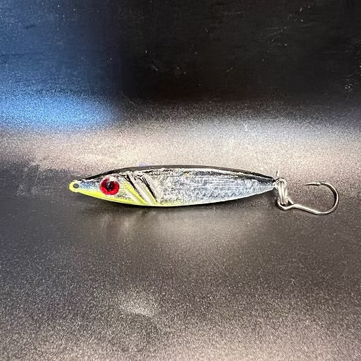 Steelie Dan 3/4 oz jigging spoon, silvery body with yellow head and red eye