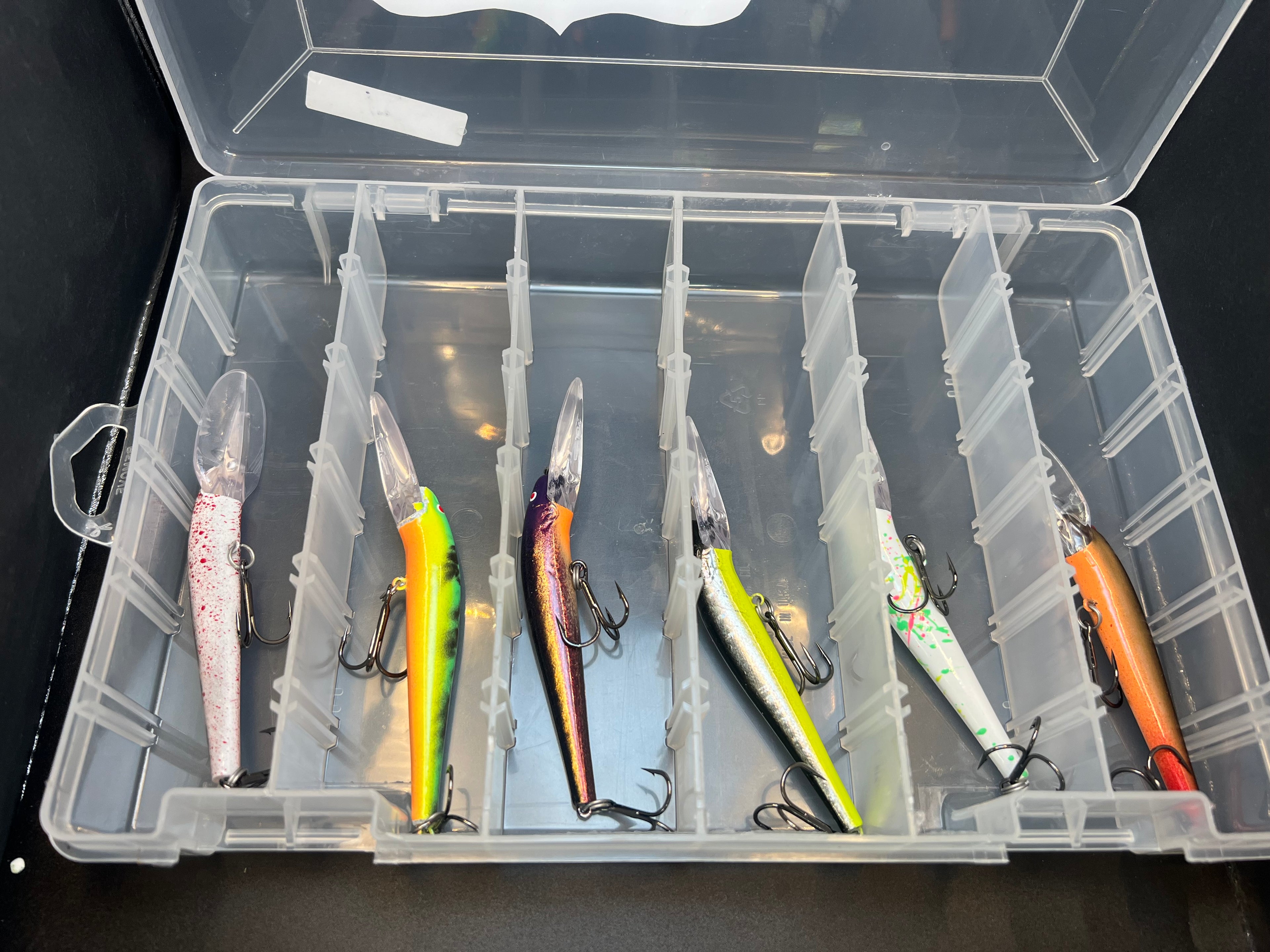 Lightningstick Box with clear divider holding 6 colorful fishing lures