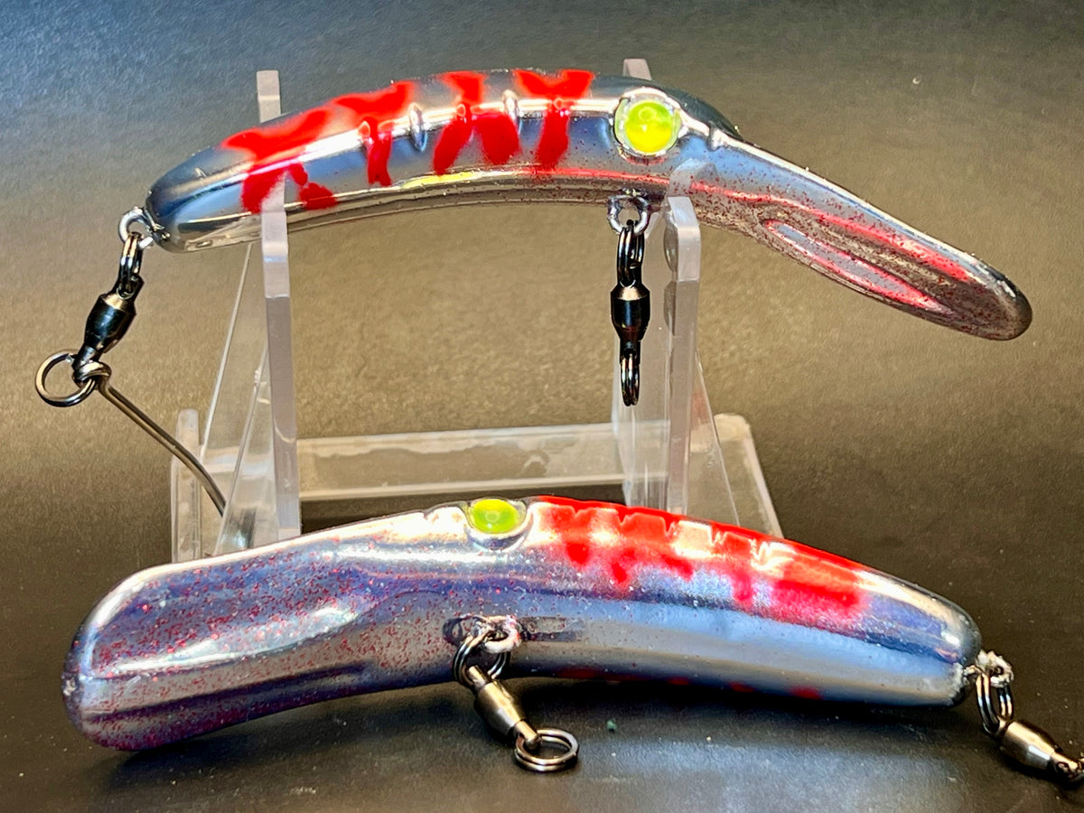 Chrome fishing lure plug with red streaks and treble hooks, two views
