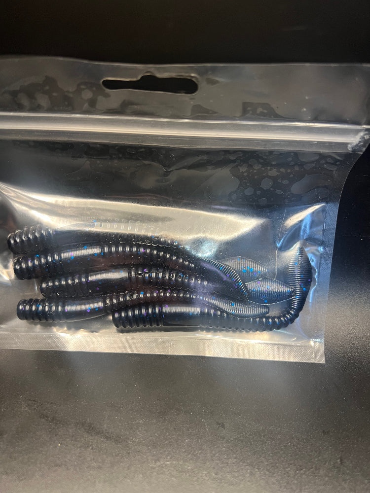Soft plastic crawler bait set in dark blue and black tones inside a clear bag