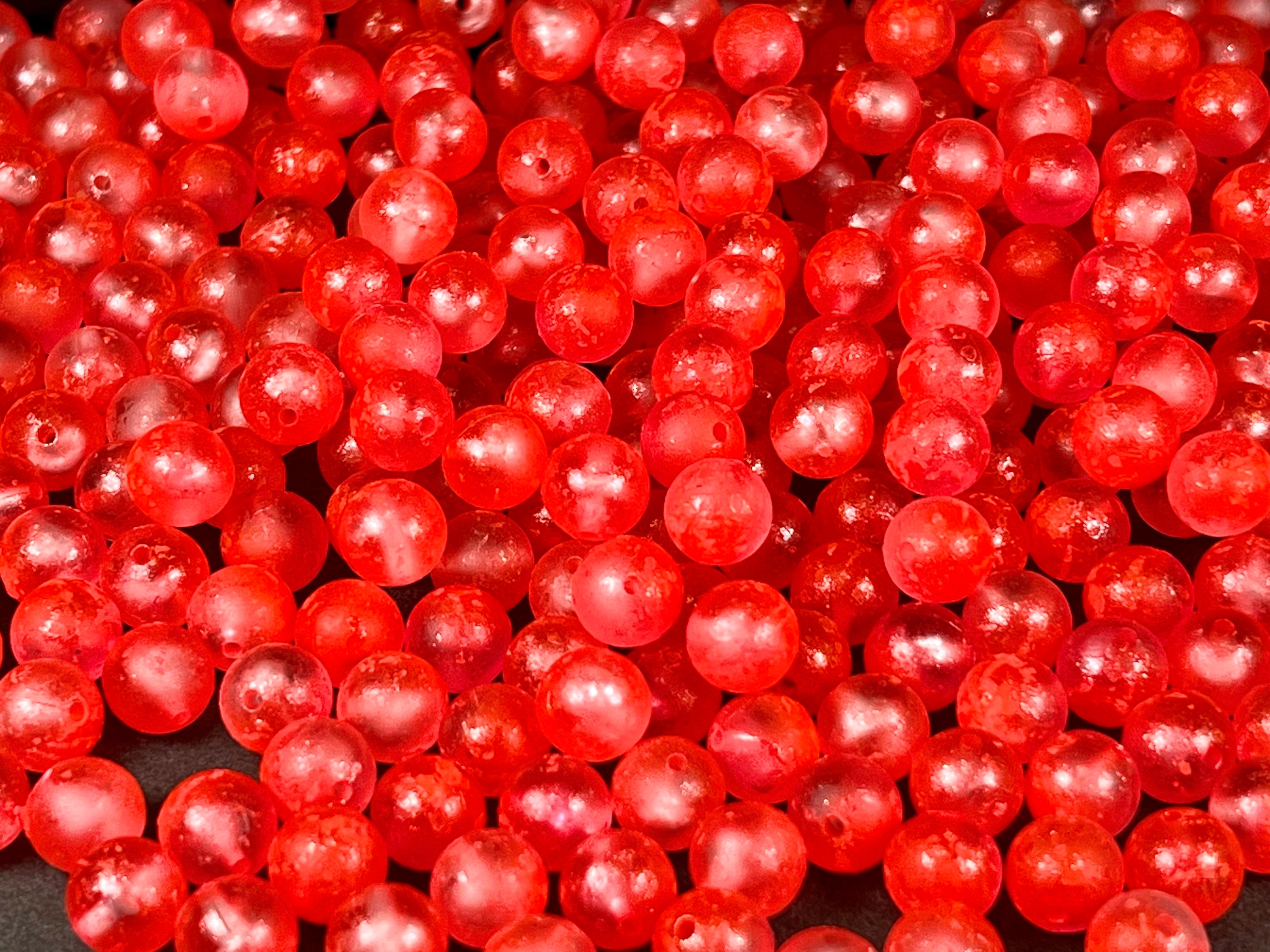 Cherry Freeze beads, bright red spheres with visible eyelet holes, bulk assortment