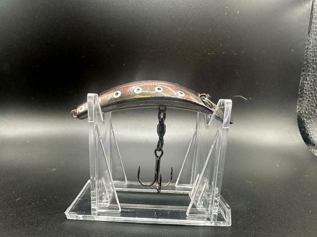 Jeremiah UV Swiftfish lure on clear stand, brown top with white spots and metal hooks