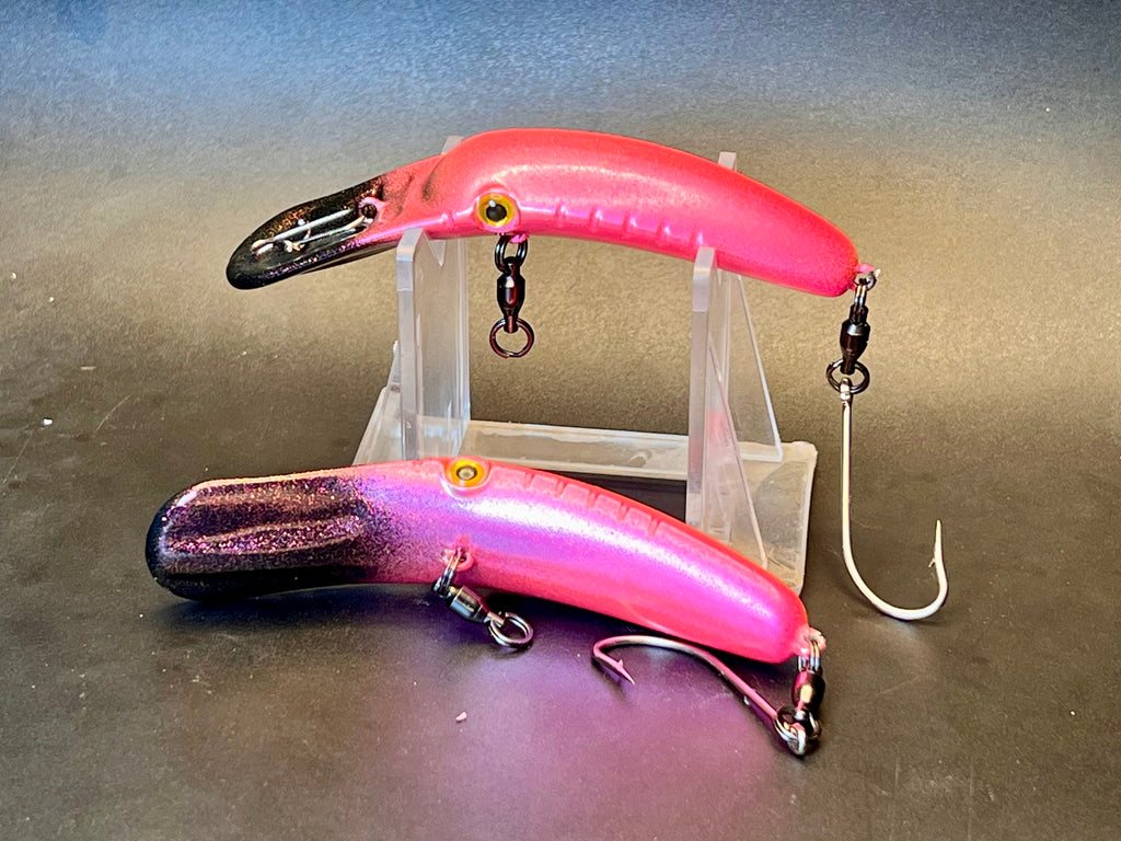 Pink glossy glitter fishing lure with treble hooks, split rings, and hanging chains