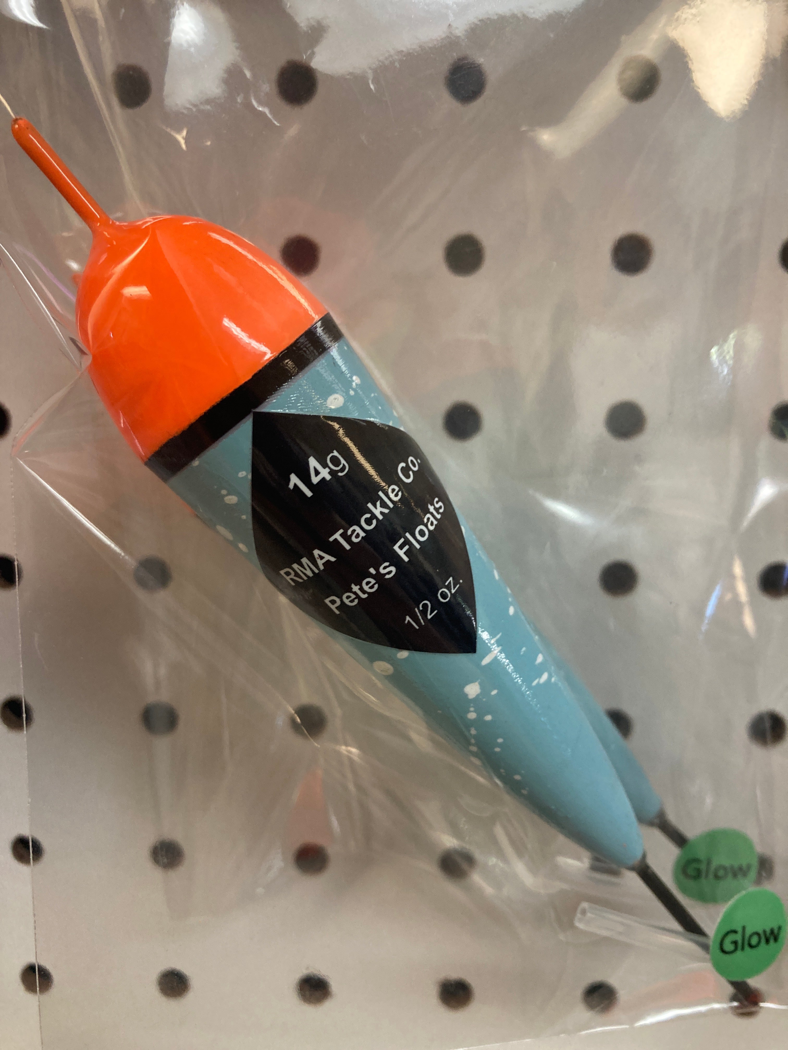 Fishing float in clear bag, orange cap with black band, blue body