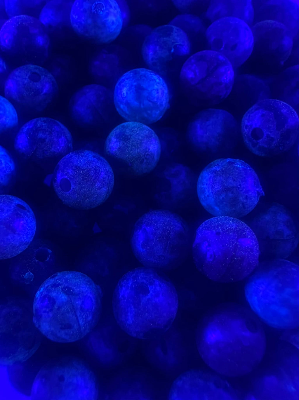 UV glow fishing beads, bright blue round plastic beads with dark speckles
