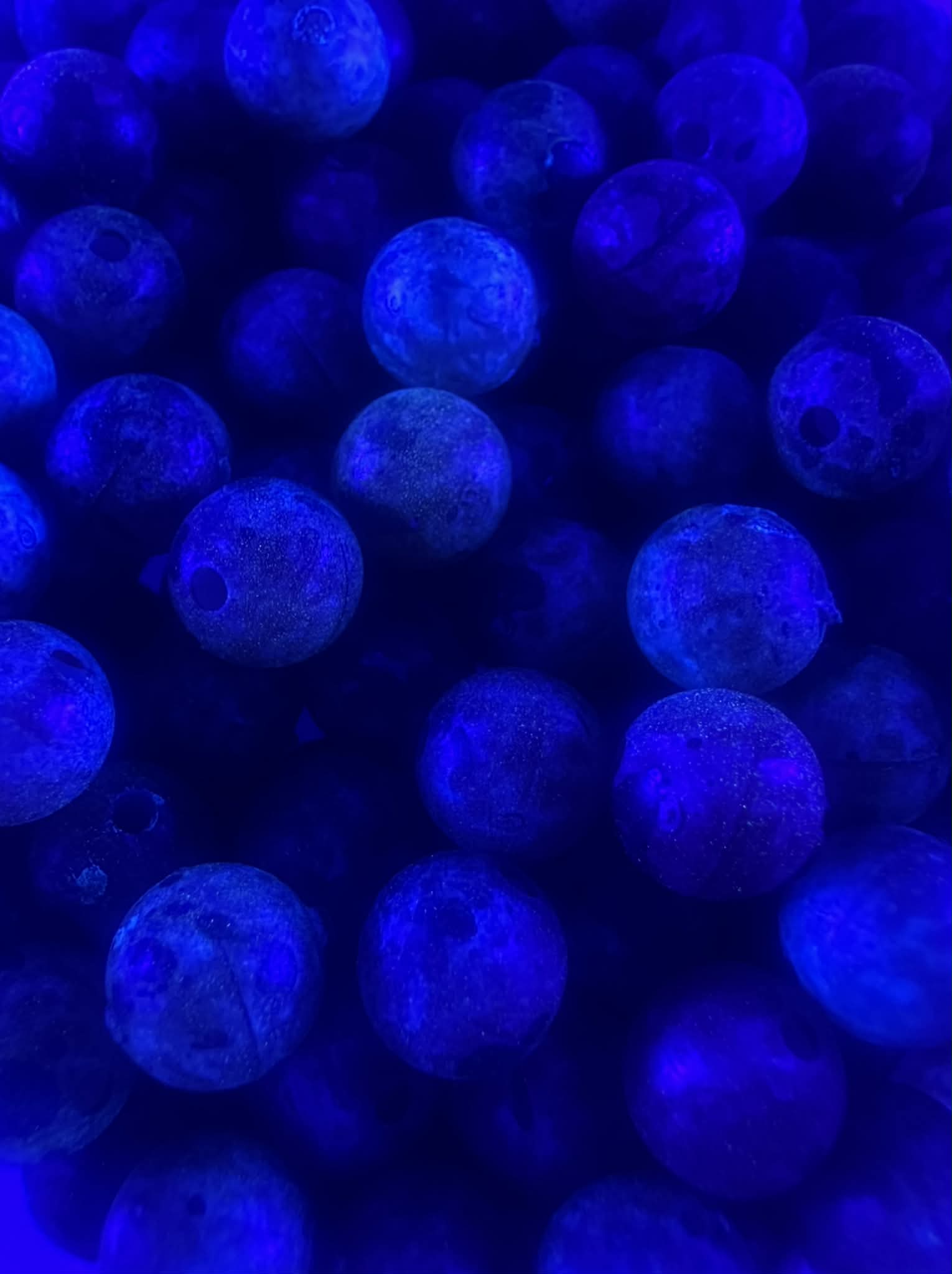 UV glow fishing beads, bright blue round plastic beads with dark speckles
