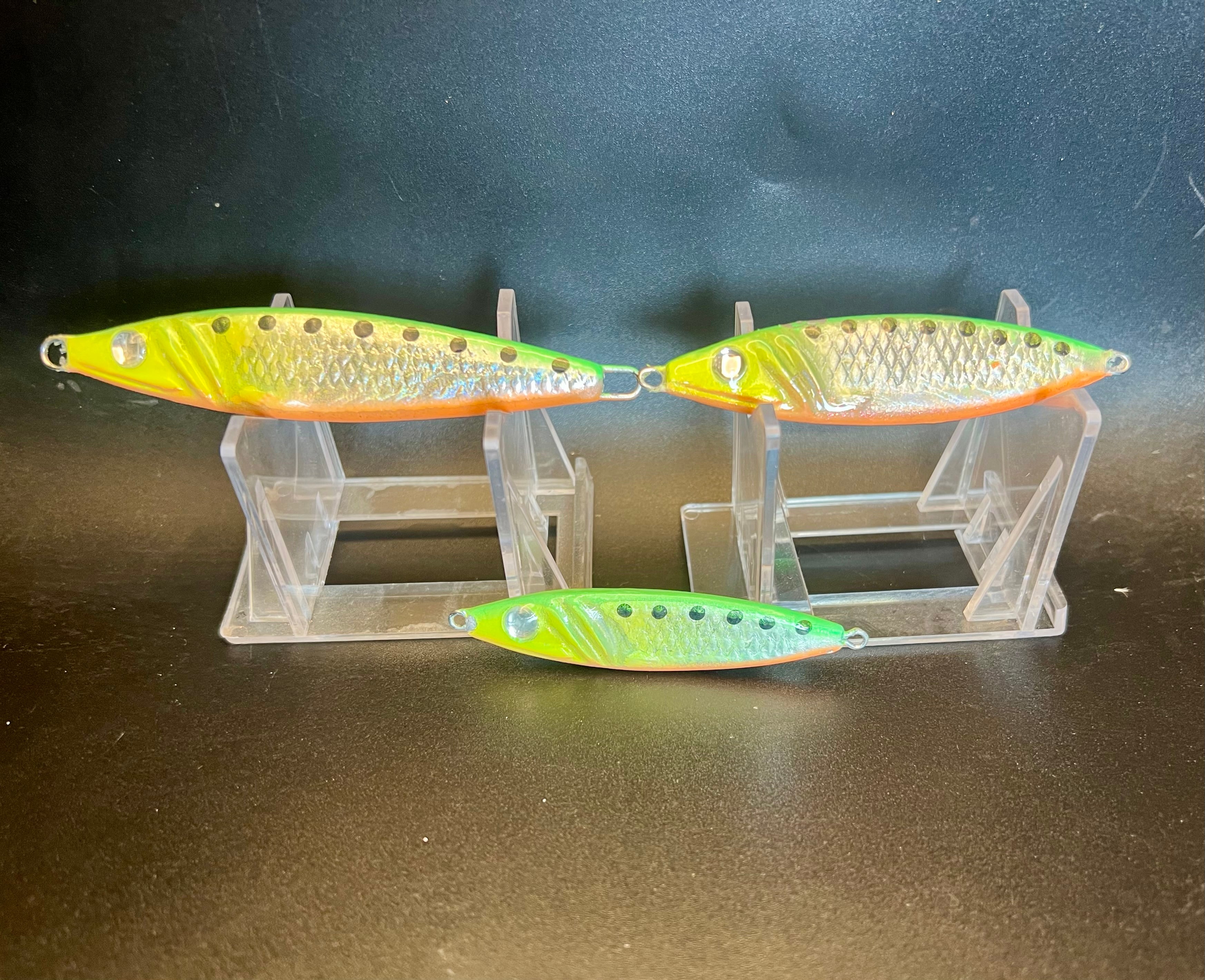 Three Tiger Kang UV Glow 1.25 oz spoons on clear rack, green-yellow/ orange