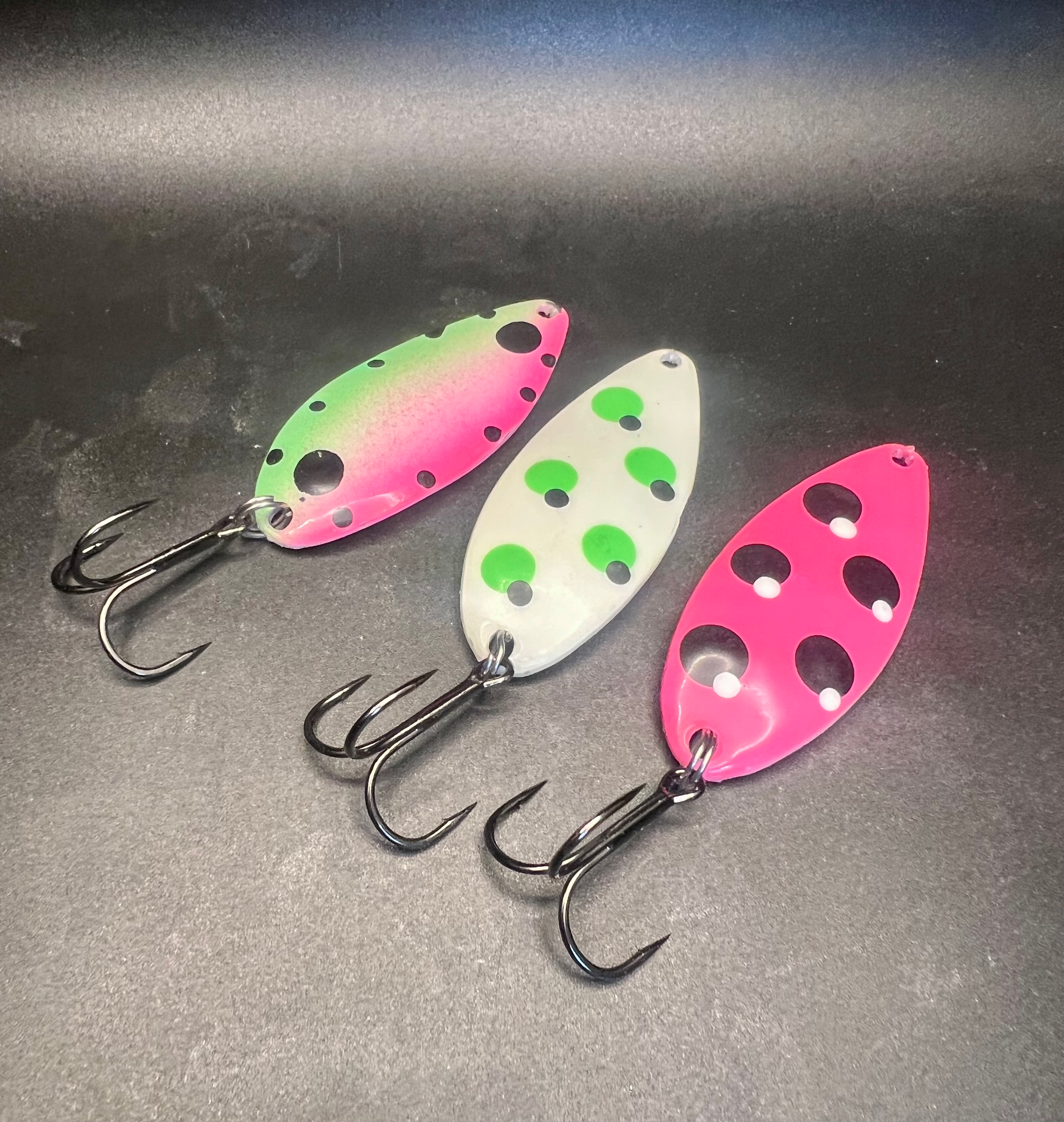 Color spoon lures with treble hooks: pink, white-green, and pink-red dot patterns