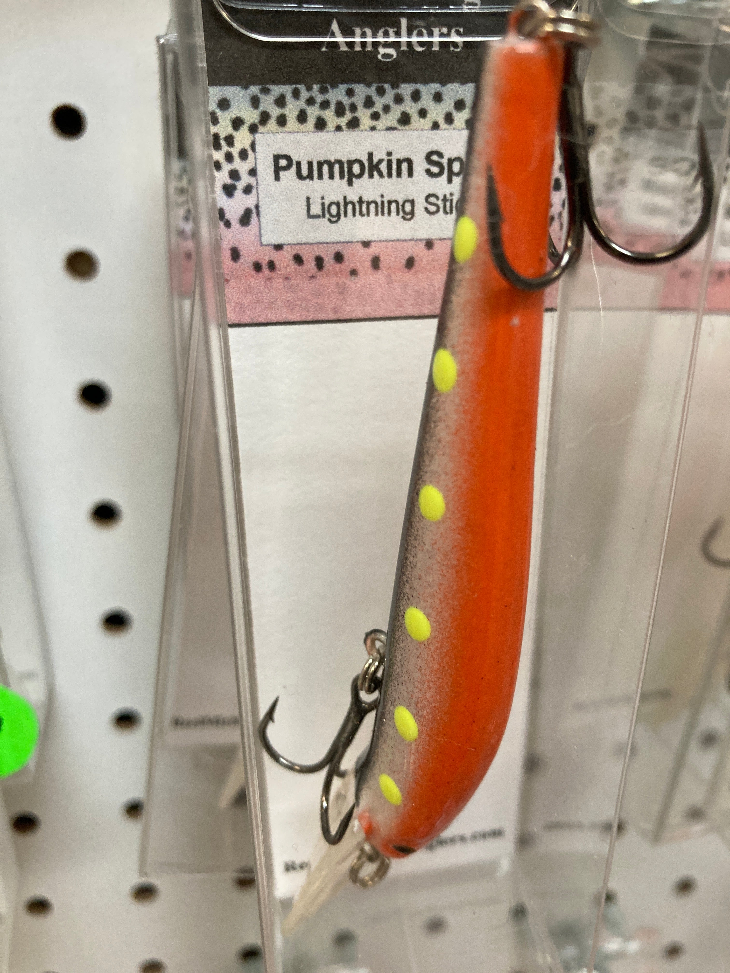 Orange fishing lure with yellow dot pattern and treble hooks, #6 hook.