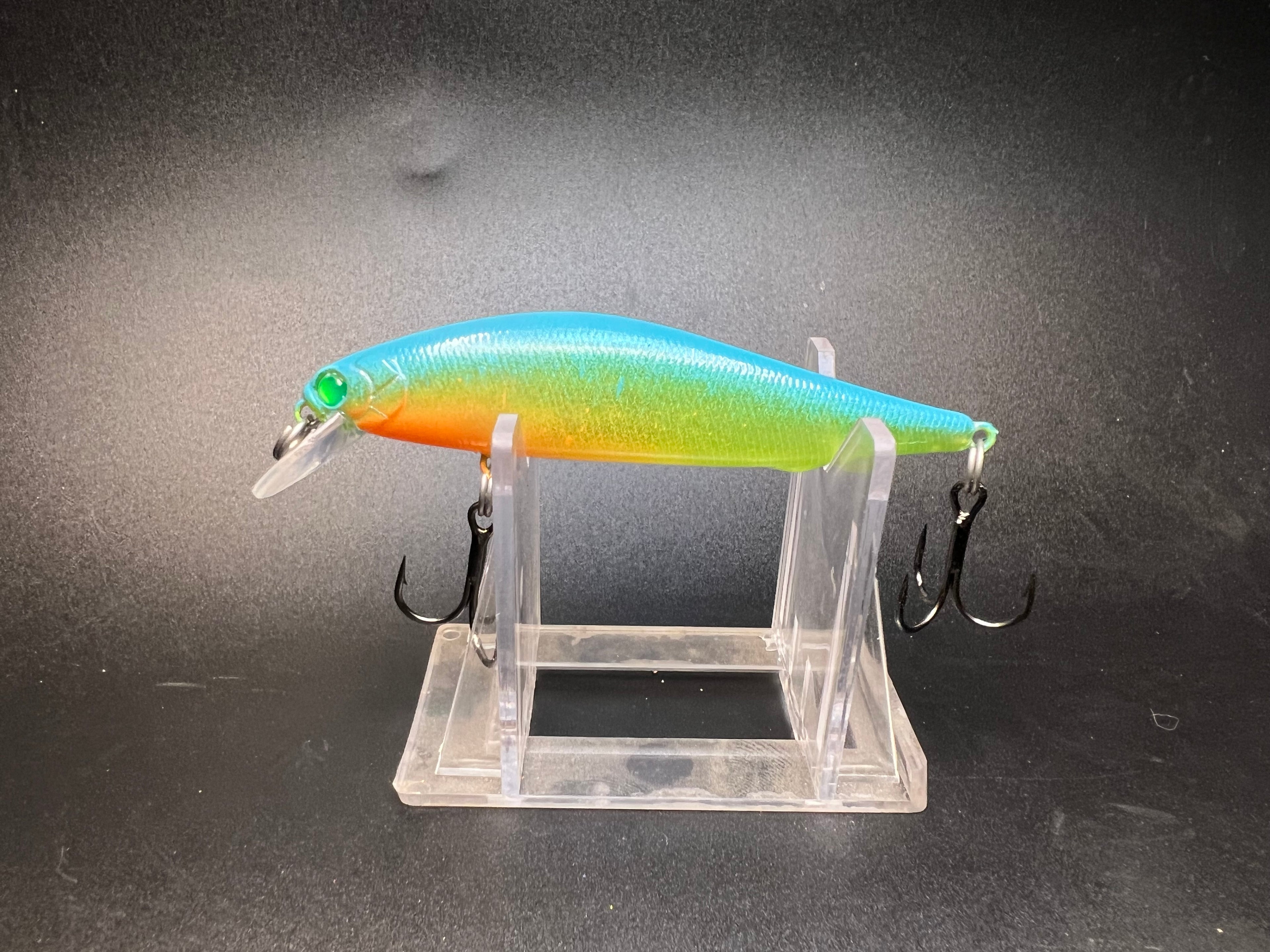Multicolor fishing jerkbait lure with two treble hooks, rainbow gradient finish.