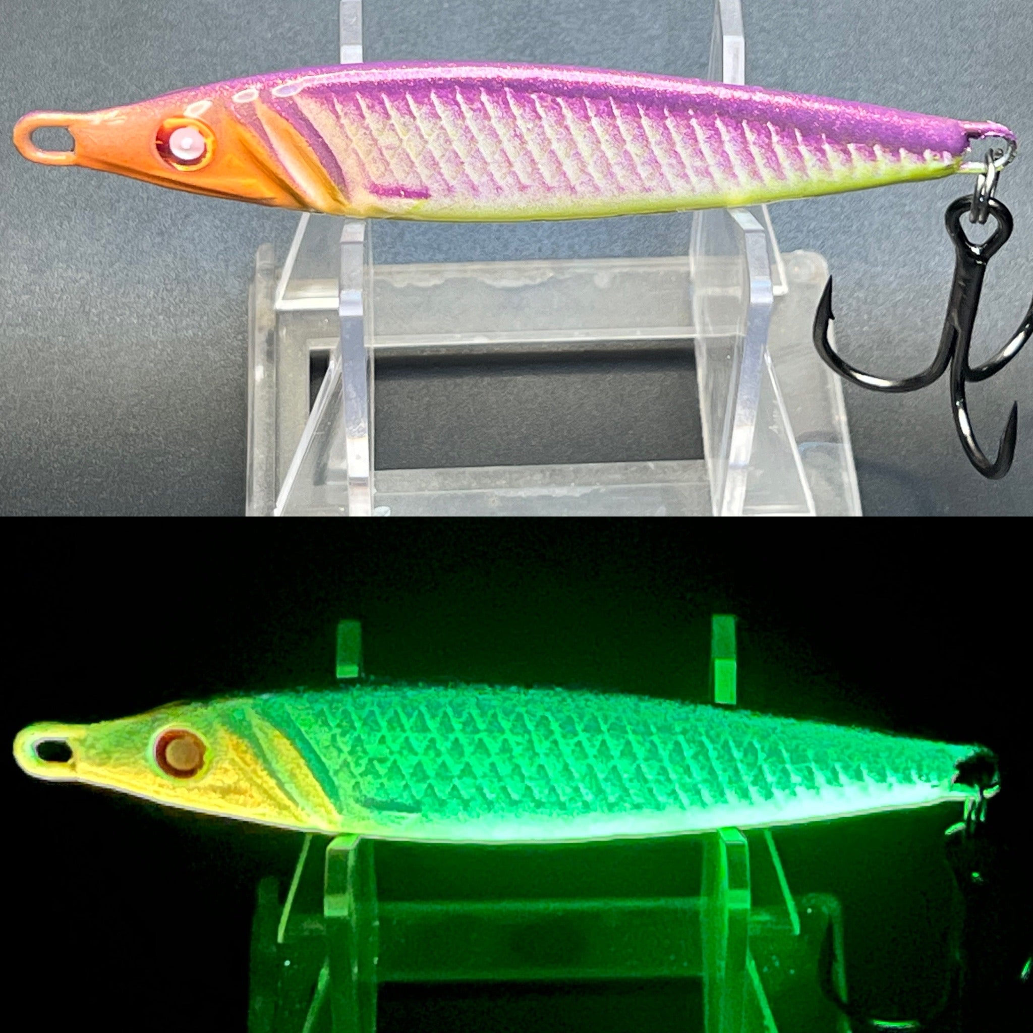 Two-tone jigging spoon lure with hook; purple-pink scales, orange head, green UV glow