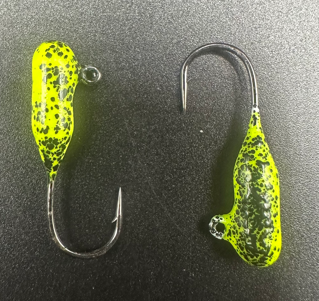Two neon yellow-green steelhead tube jigs with black speckles and exposed hooks