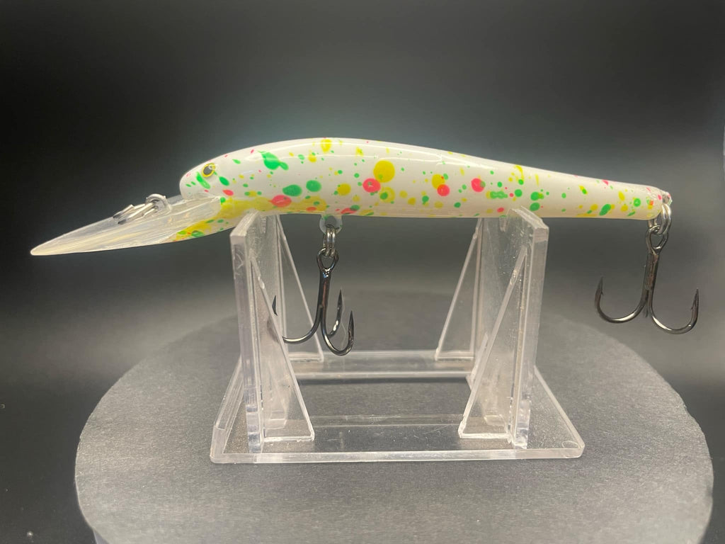 Clear plastic lure display with three metal hooks and speckled rainbow top piece