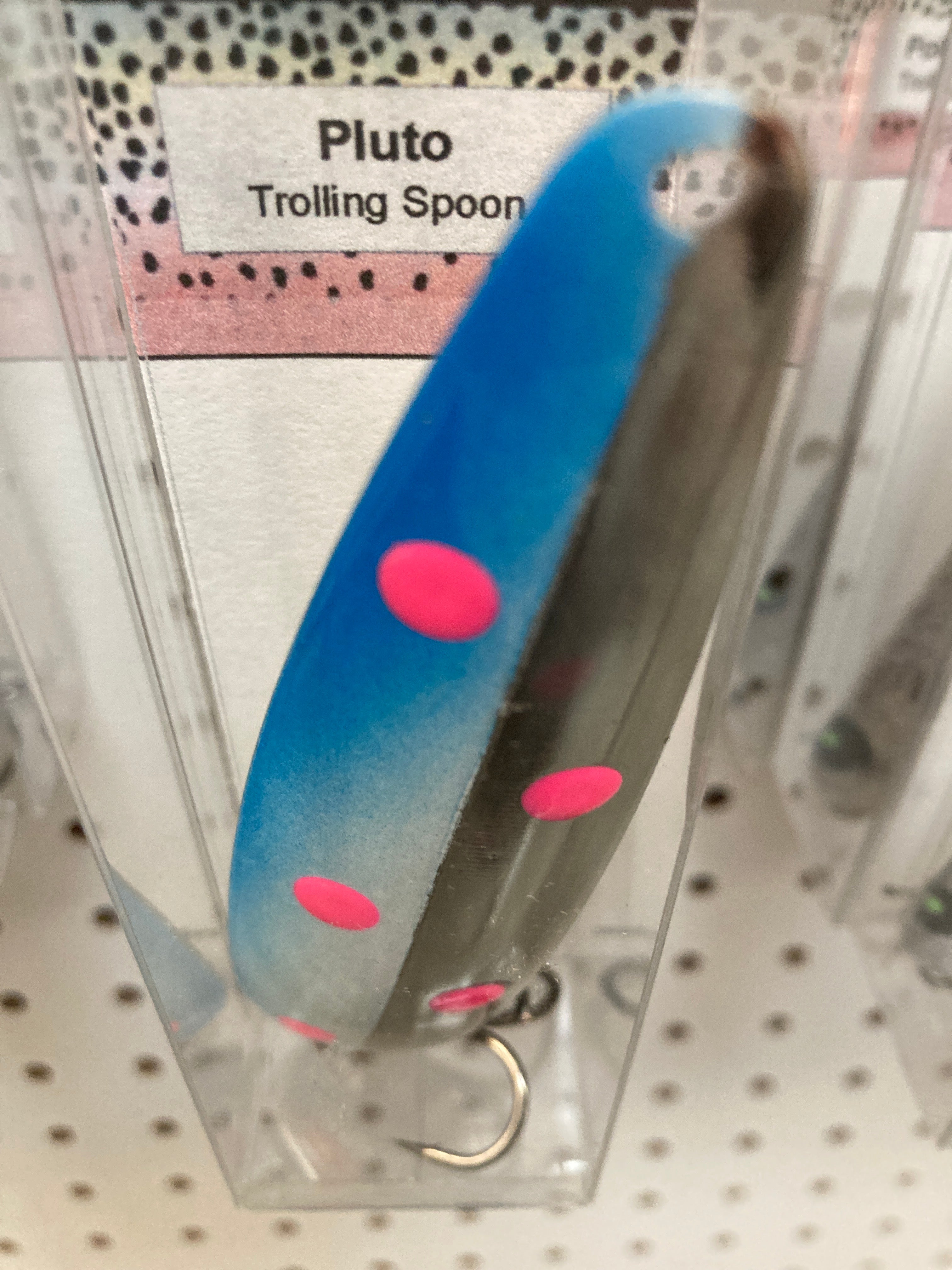 Blue trolling spoon with pink spots, in retail blister pack