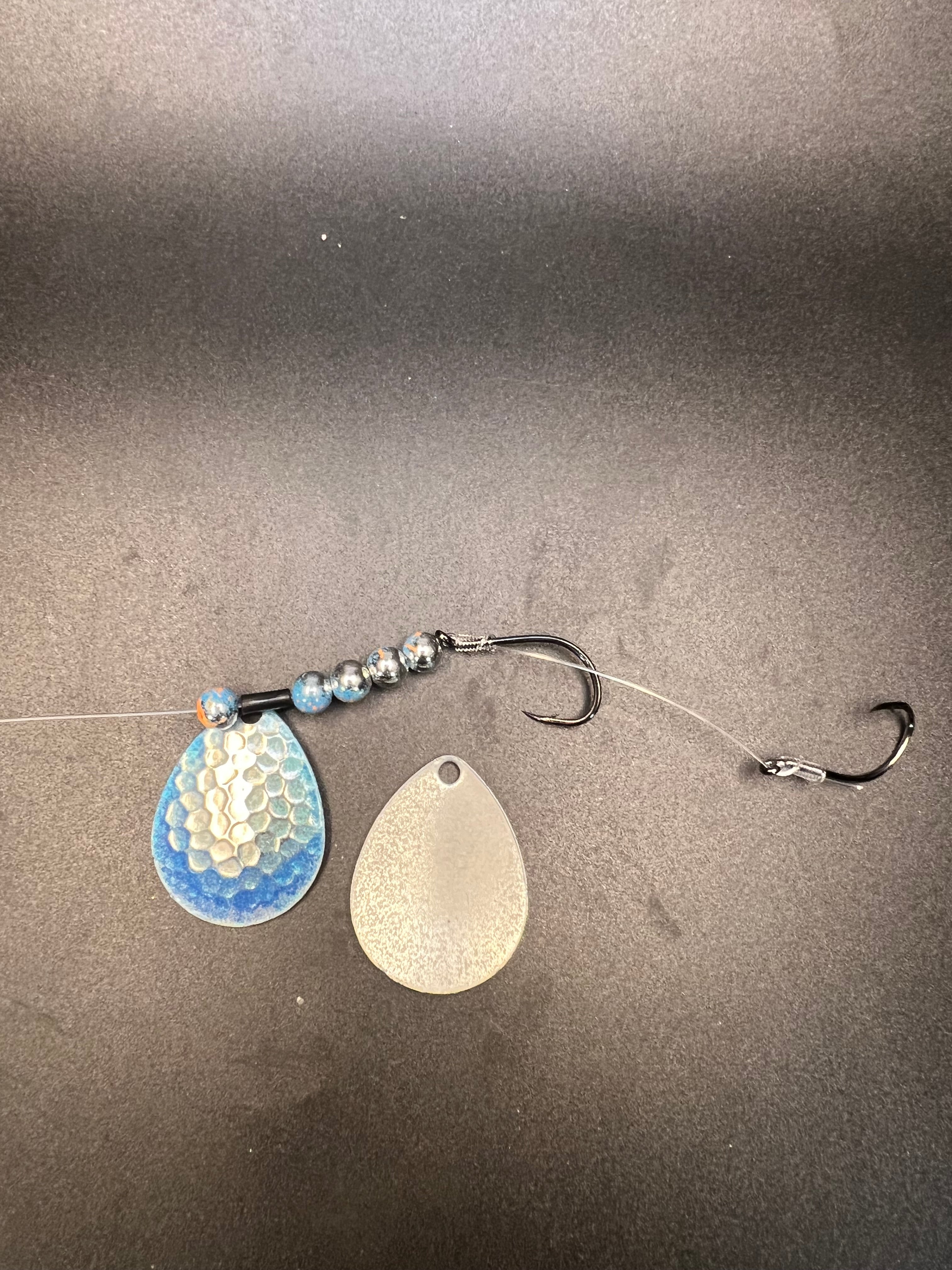 Fishing lure harness with blue and silver teardrop blades and two treble hooks