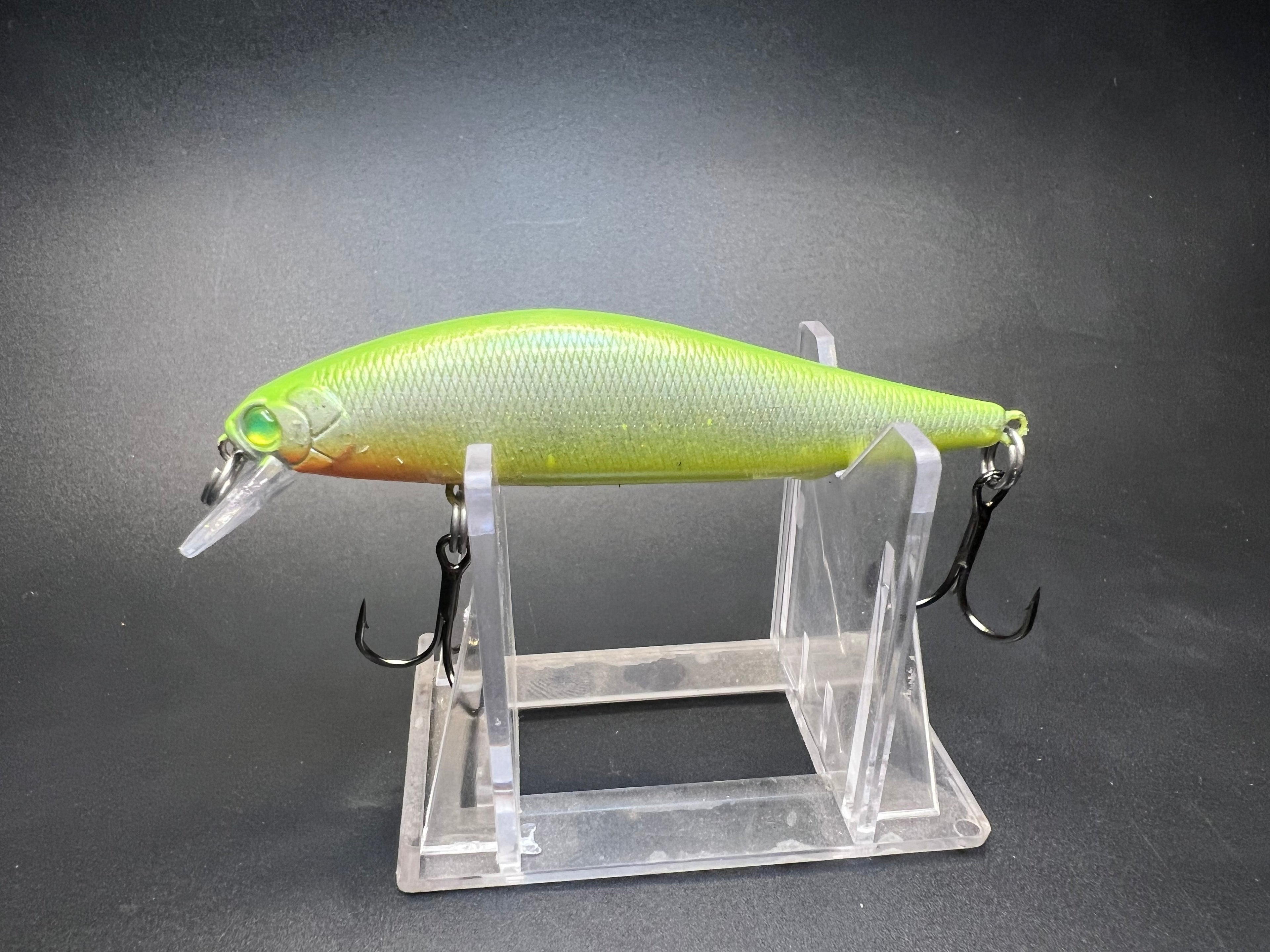 Lime green and yellow jerkbait fishing lure with two treble hooks