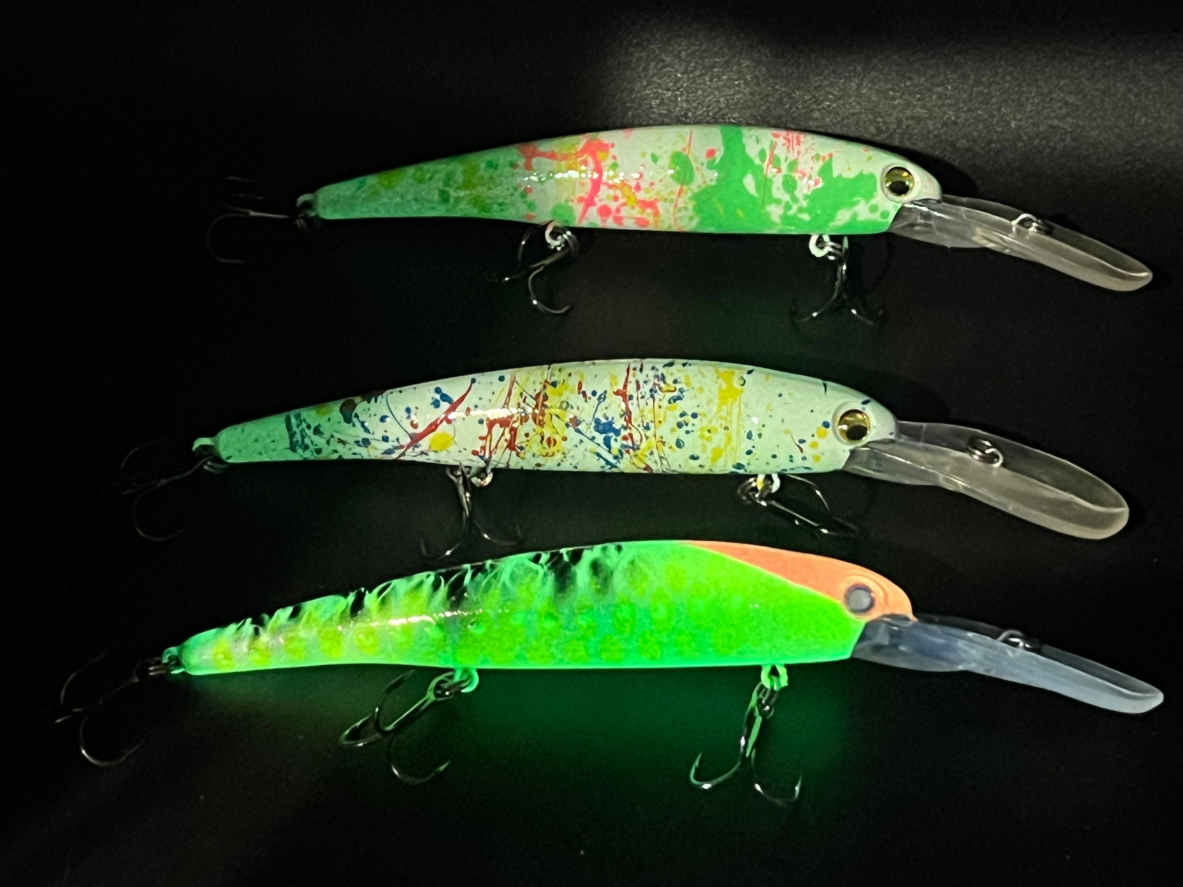 Assorted walleye trolling lures: green, multicolor, and orange with clear lips