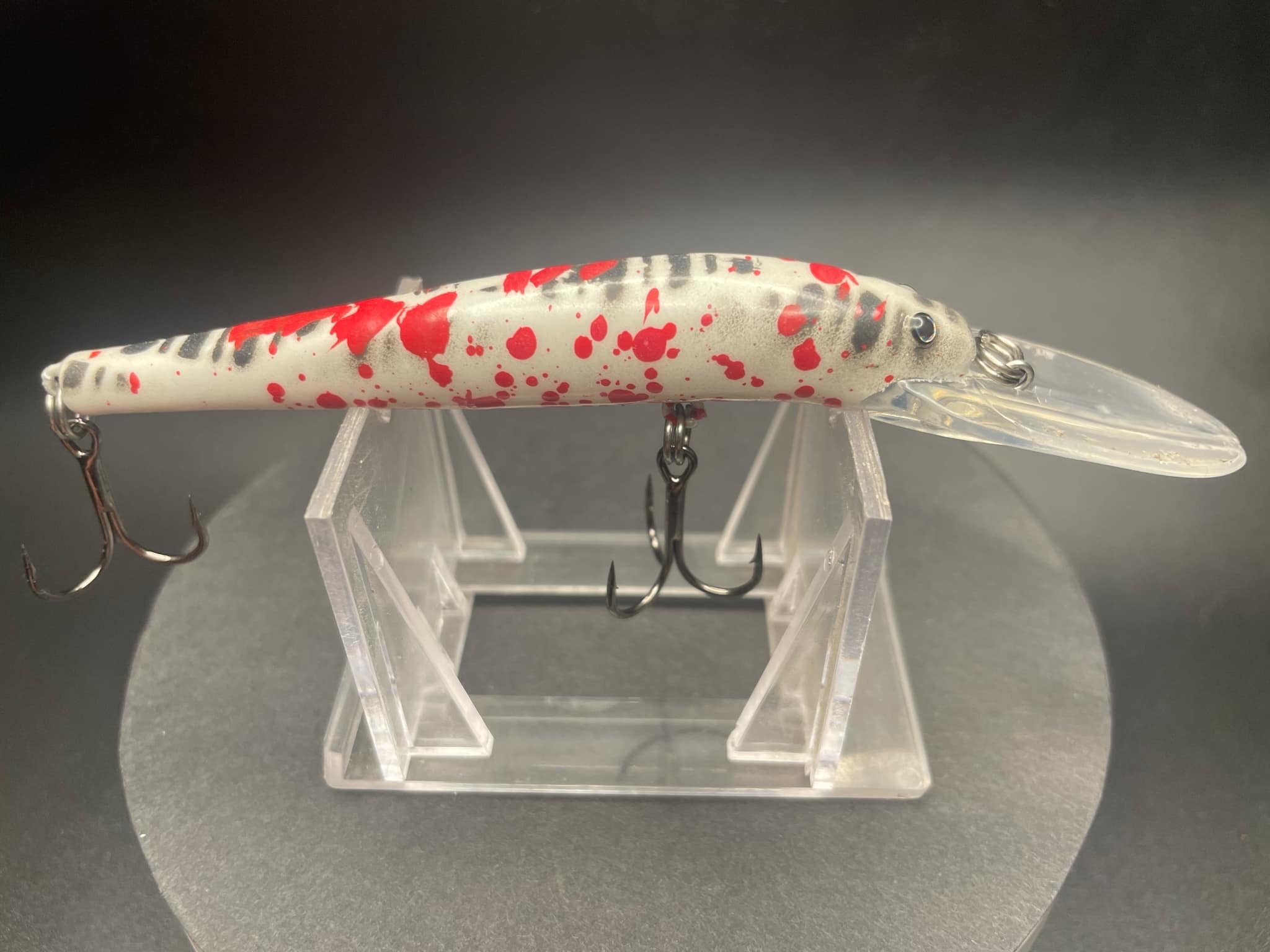 Lightningstick lure, white with red splatter and clear lip; treble hooks