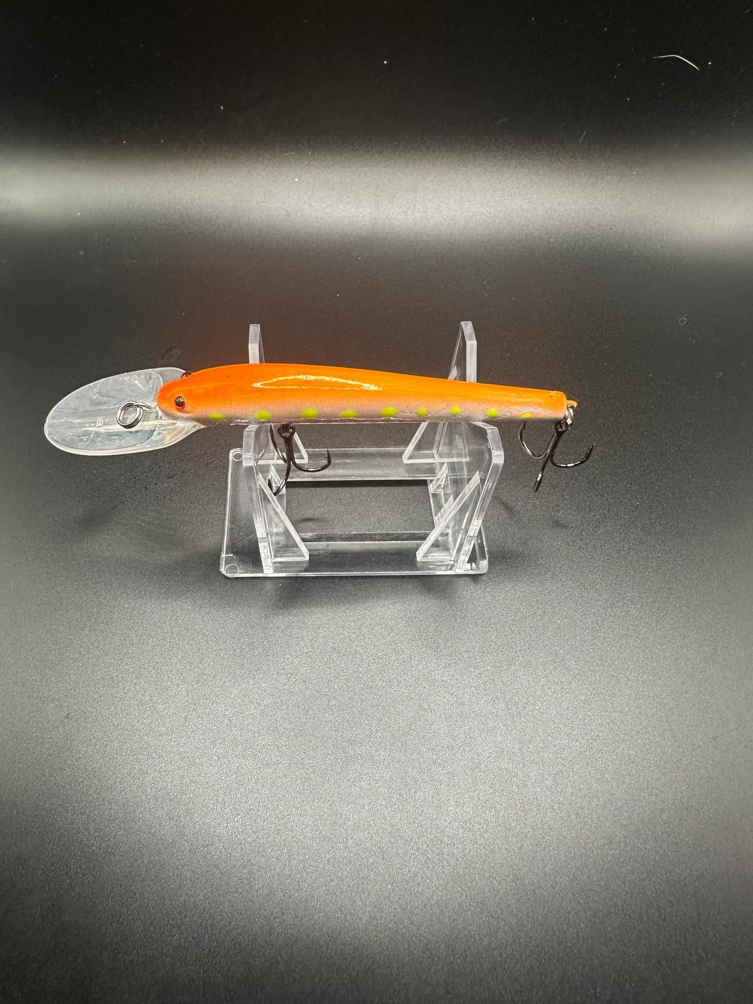 Orange Lightningstick crankbait lure with clear lip and 3X strong treble hooks