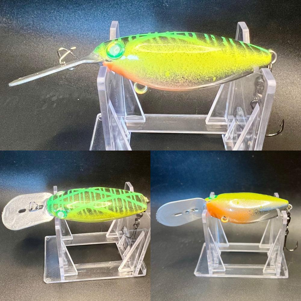 Lime-green and yellow trolling plug with side treble hooks on clear display stand