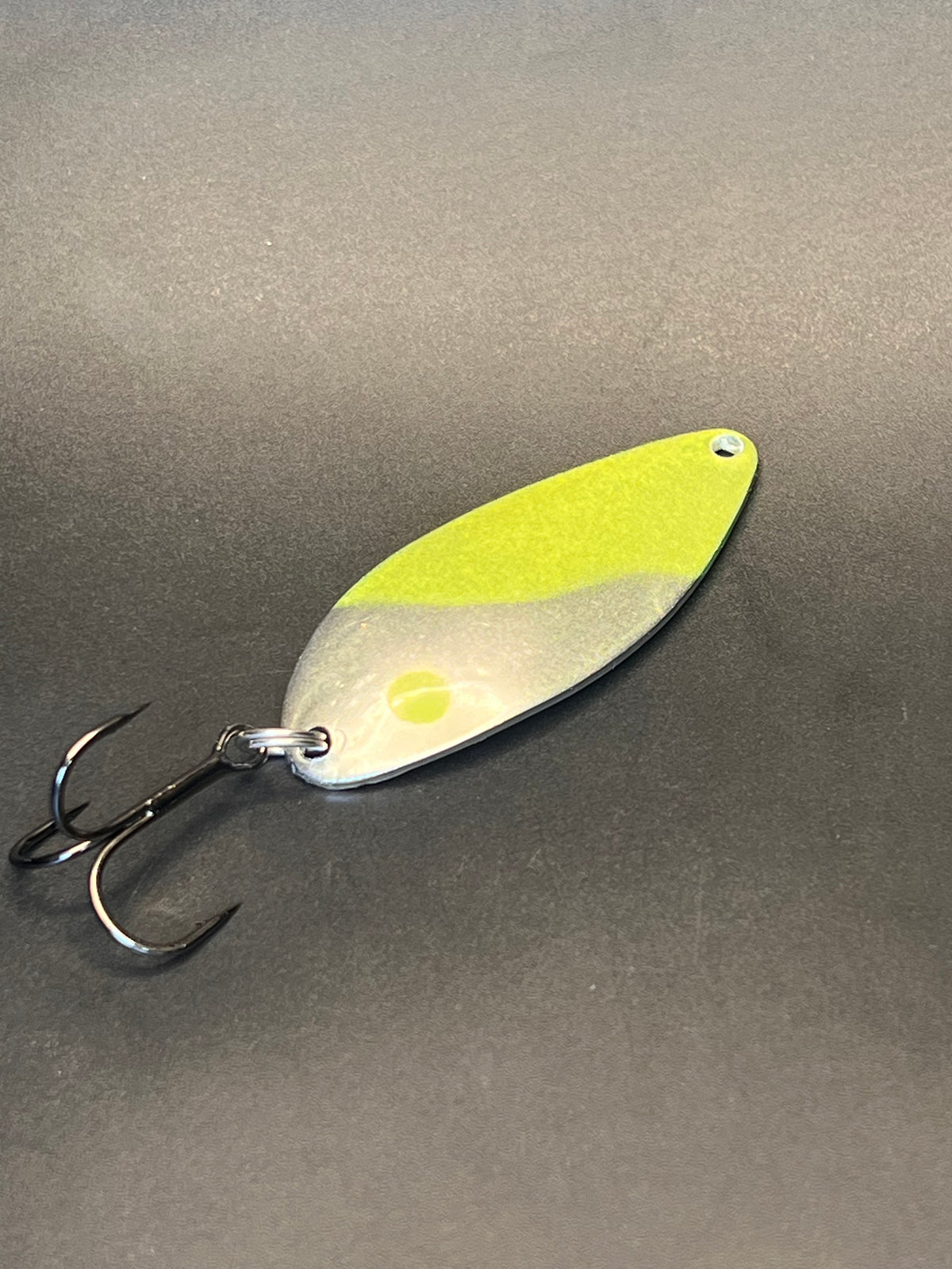 Chartreuse fishing casting spoon with silver body and treble hook
