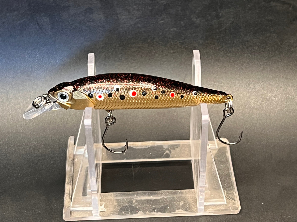 Gold trout jerkbait with clear diving lip, painted spots, and two treble hooks