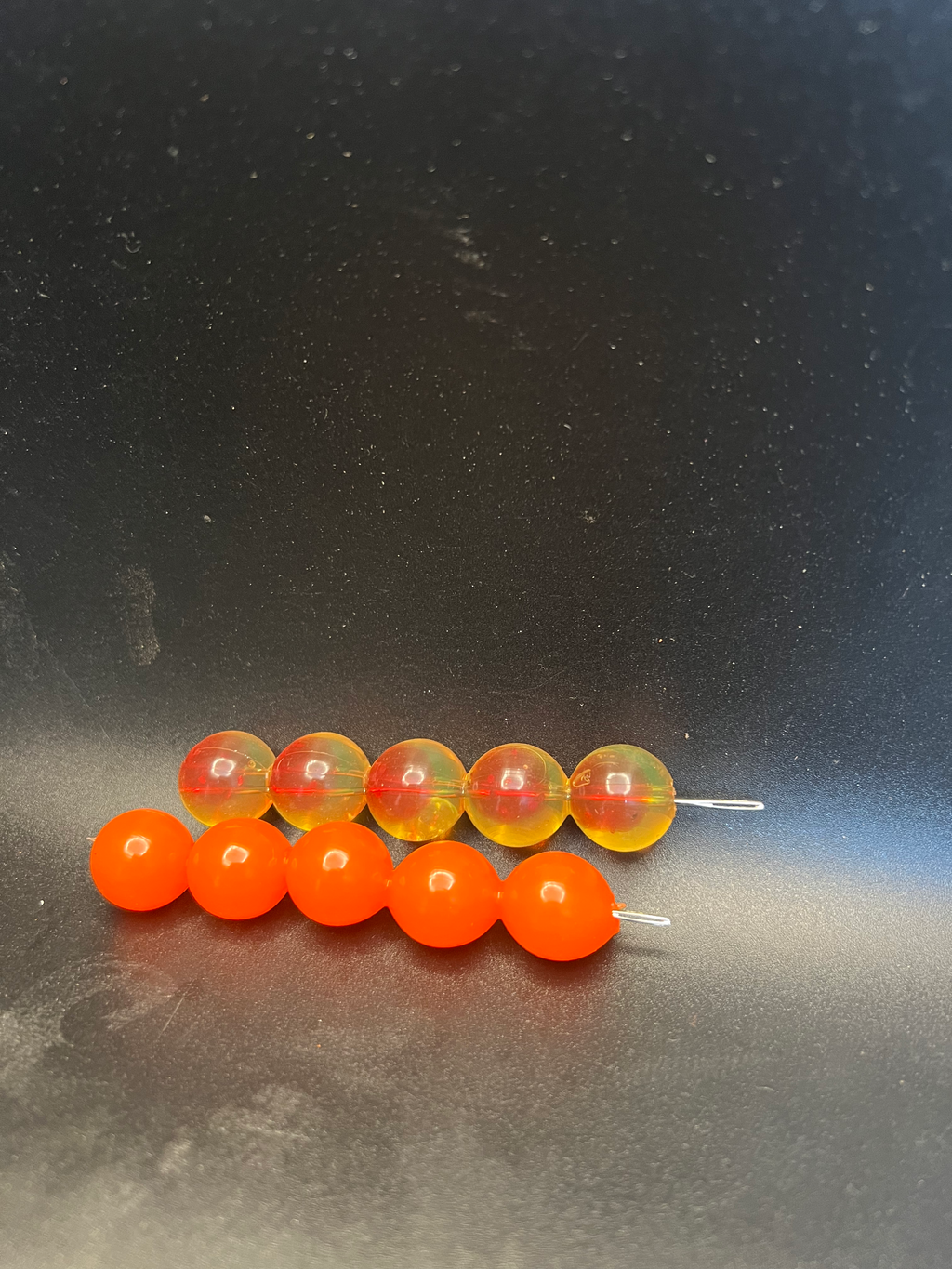 Soft plastic embryo beads with small wire hooks; orange and red translucent beads