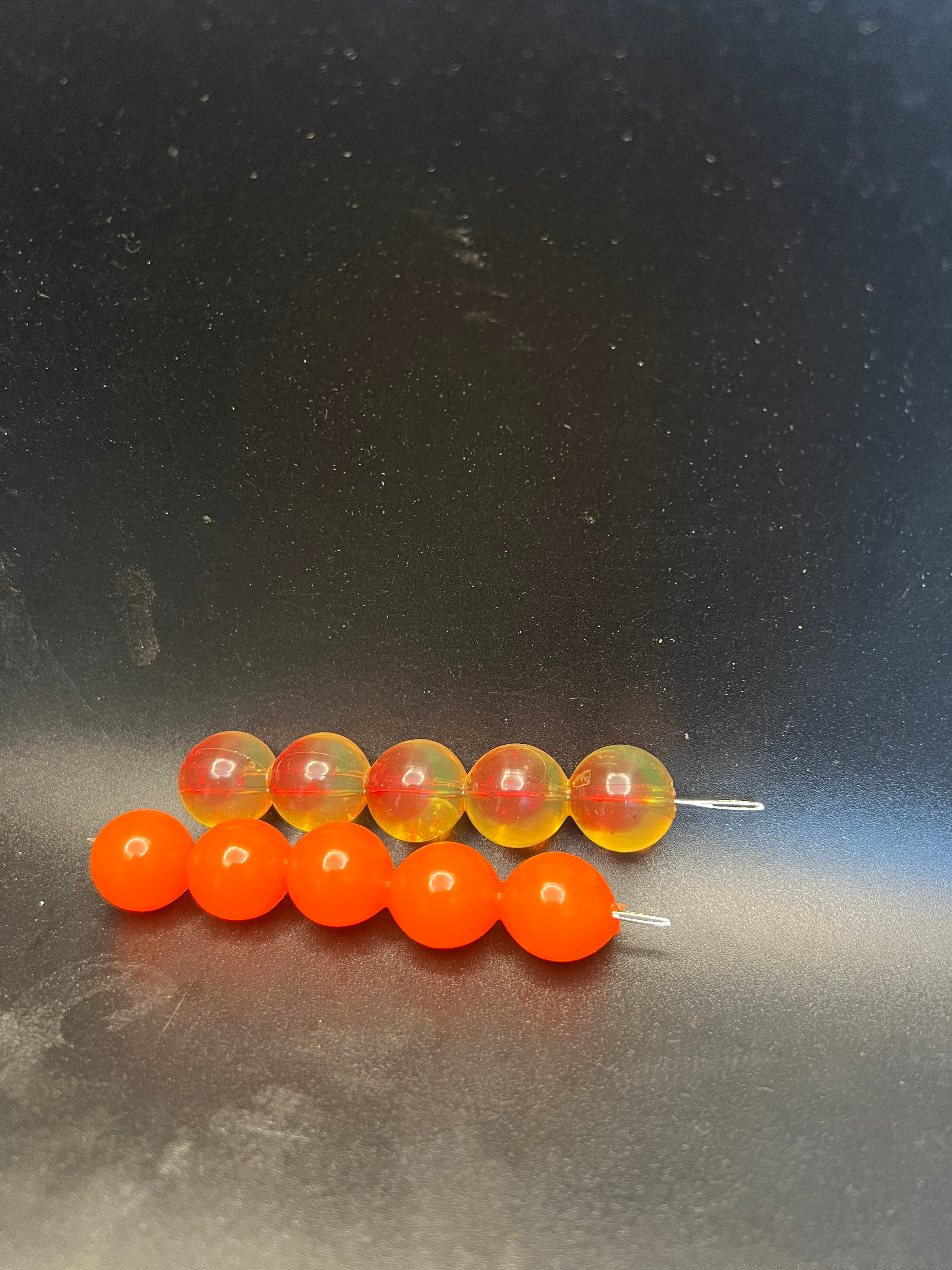 Soft plastic embryo beads with small wire hooks; orange and red translucent beads