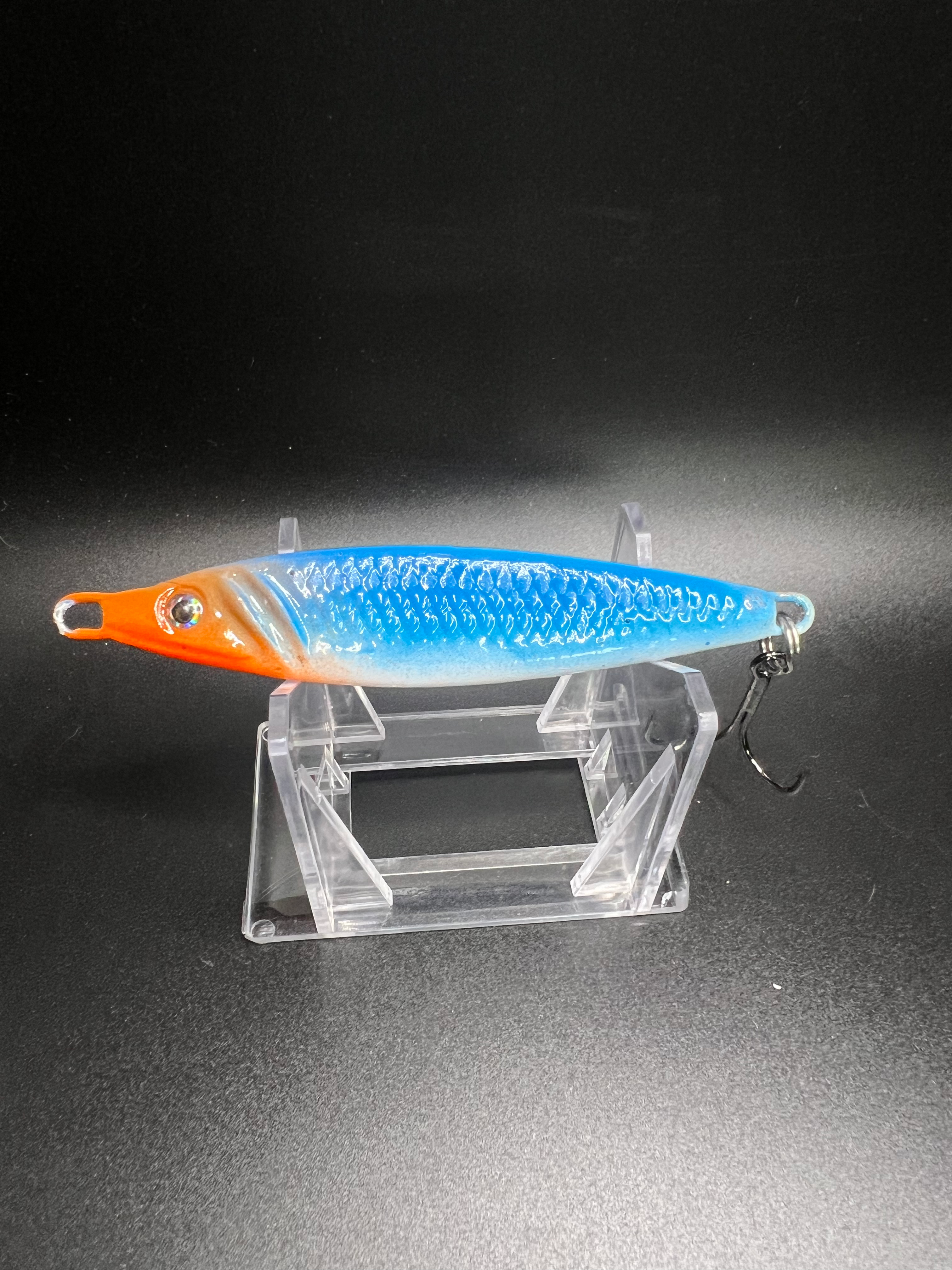 Ice Nine Gills 2 oz jigging spoon, orange head and blue metallic body with hook