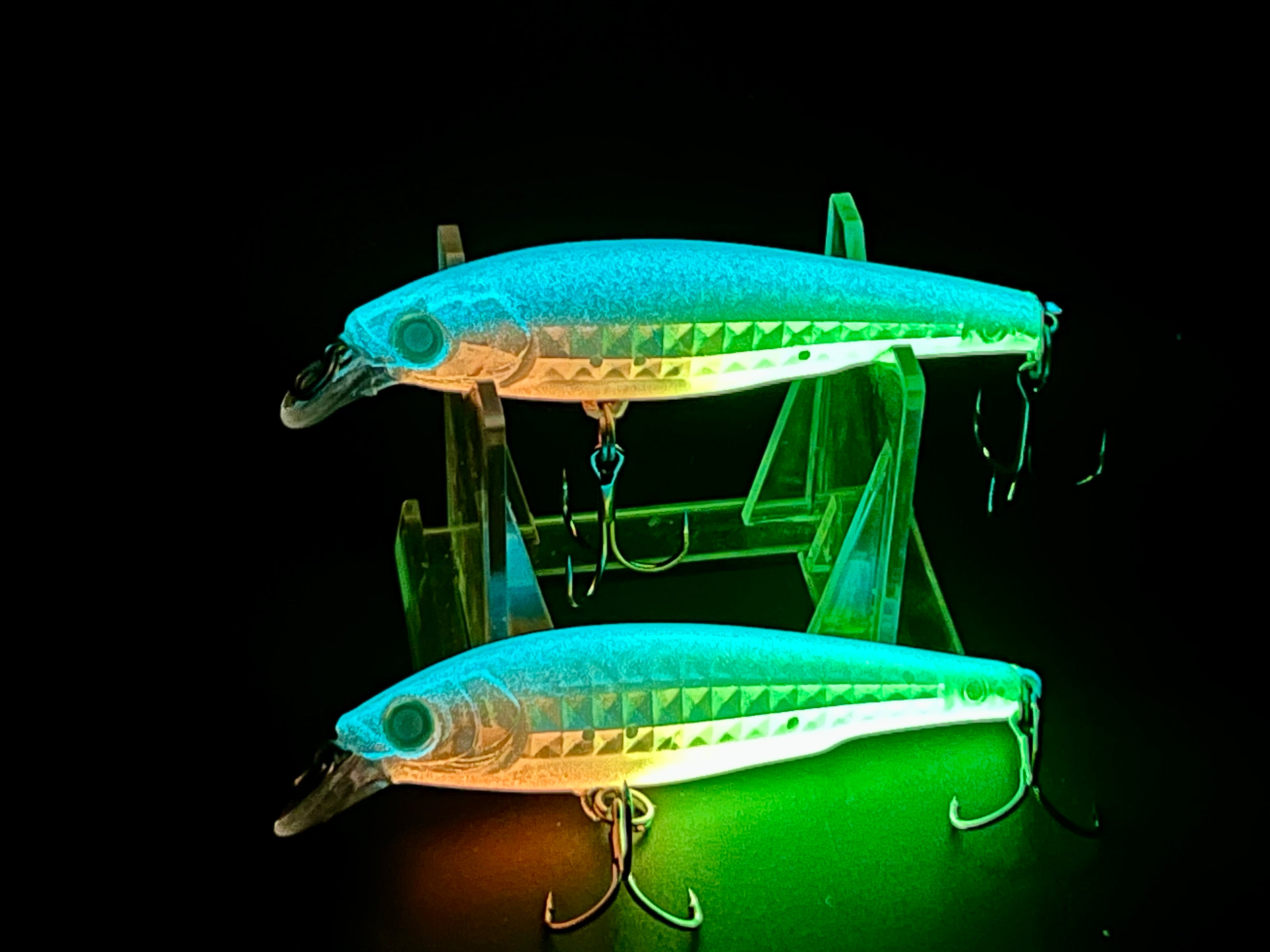 Glow teal and green fishing jerkbait lures with treble hooks