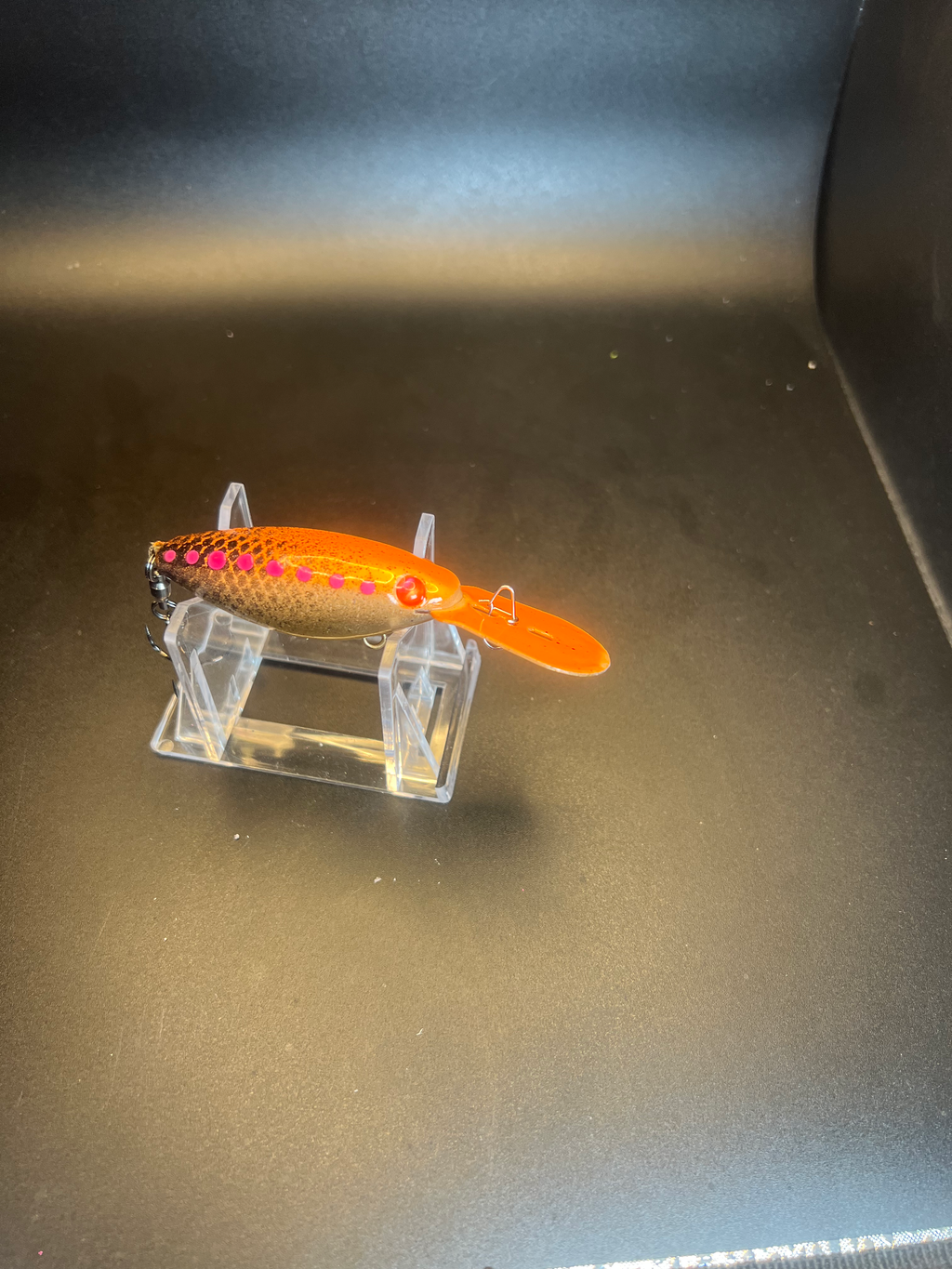 Side view orange trolling plug with speckled back, pink dots, treble hook