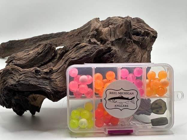 Soft plastic bead pocket box with clear compartments of pink, orange, and yellow beads