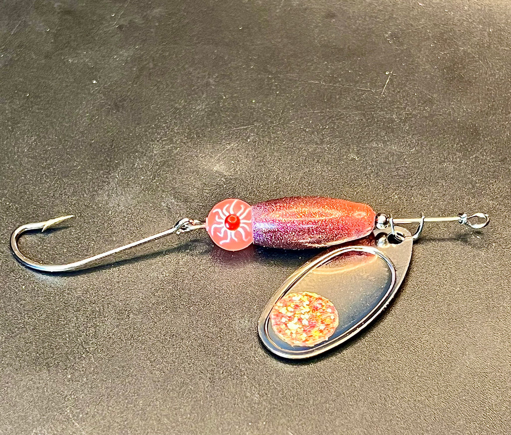 Voodoo inline spinner lure with orange-red chrome body, red spinner blade, treble hook