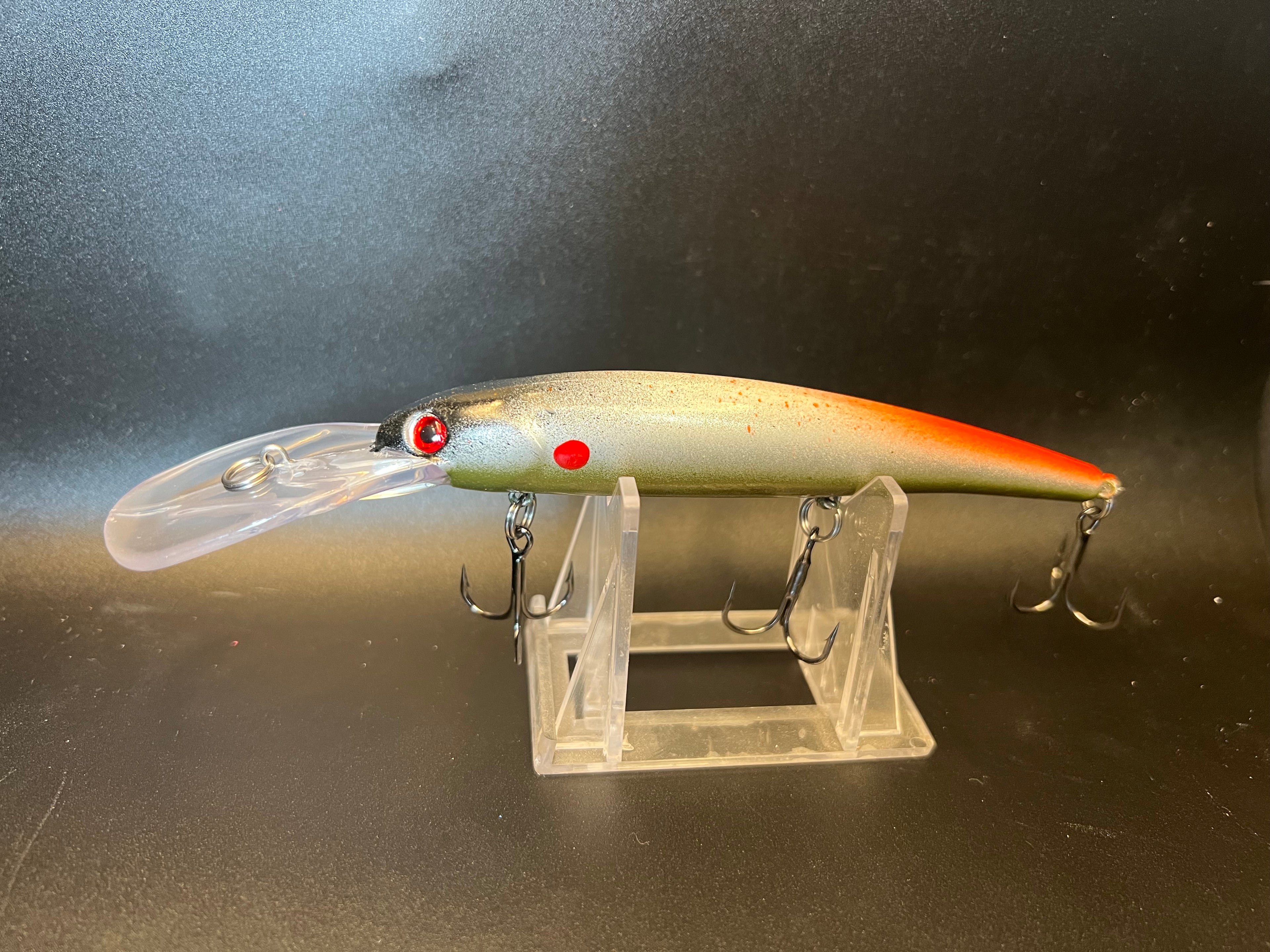 Gold-and-orange walleye trolling crankbait with red eyes, clear lip, and 3 treble hooks