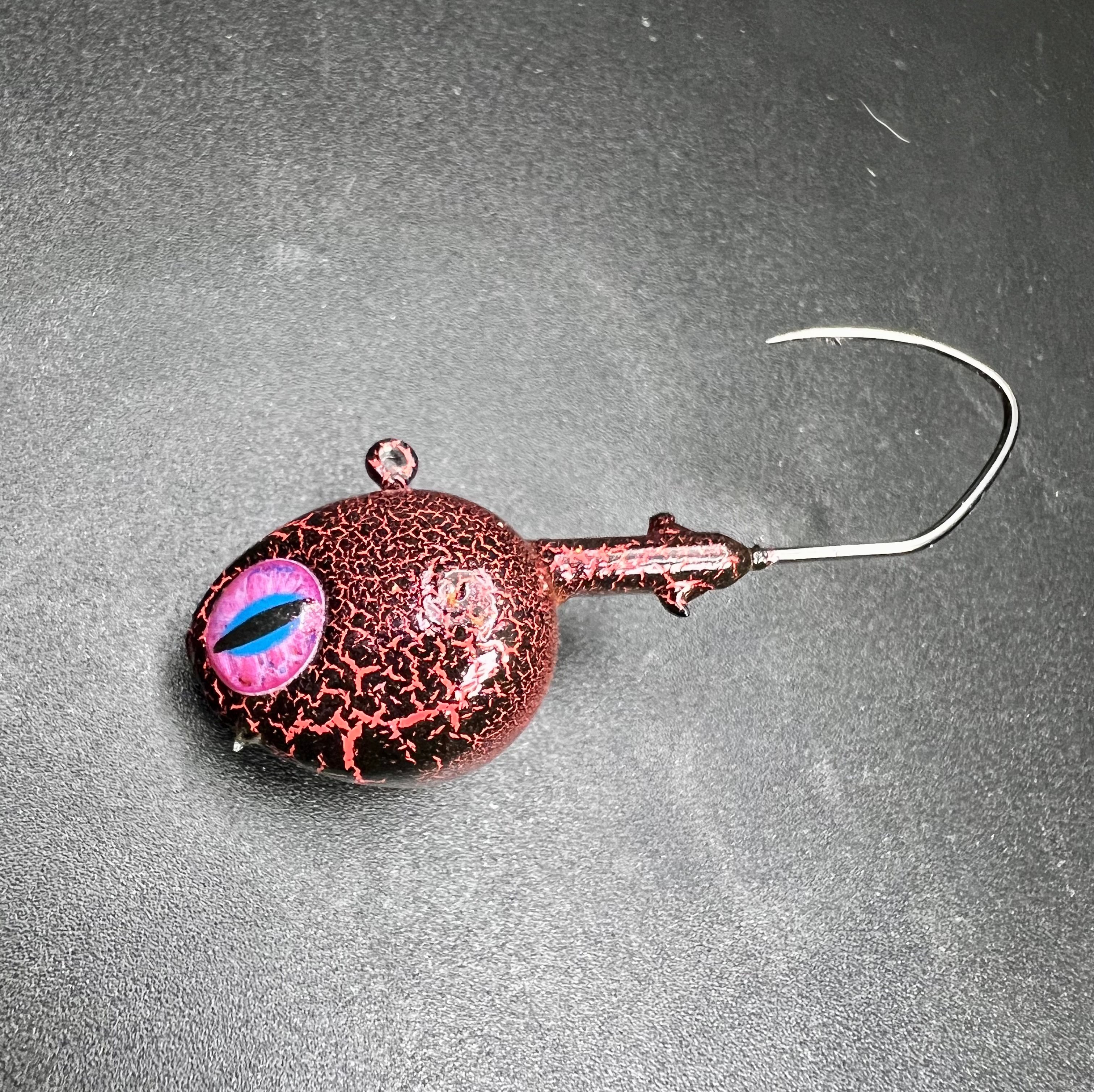 Gila Monster UV walleye jig, red copper body with holographic eye and single hook
