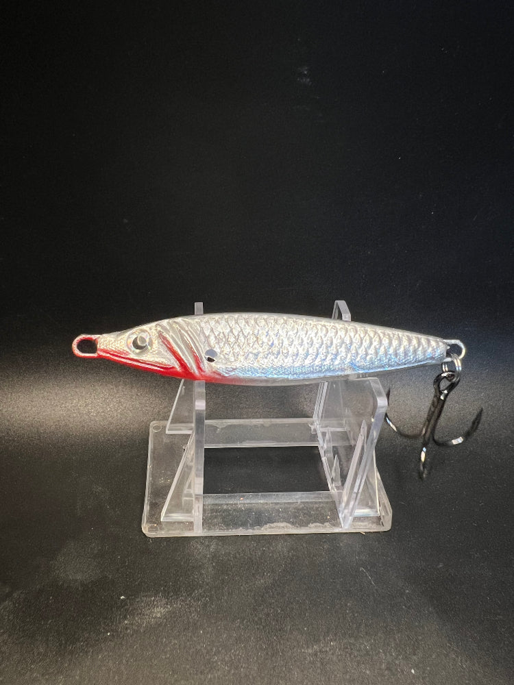 UV Glow jigging spoon 2 oz, silvery body with red head and treble hooks