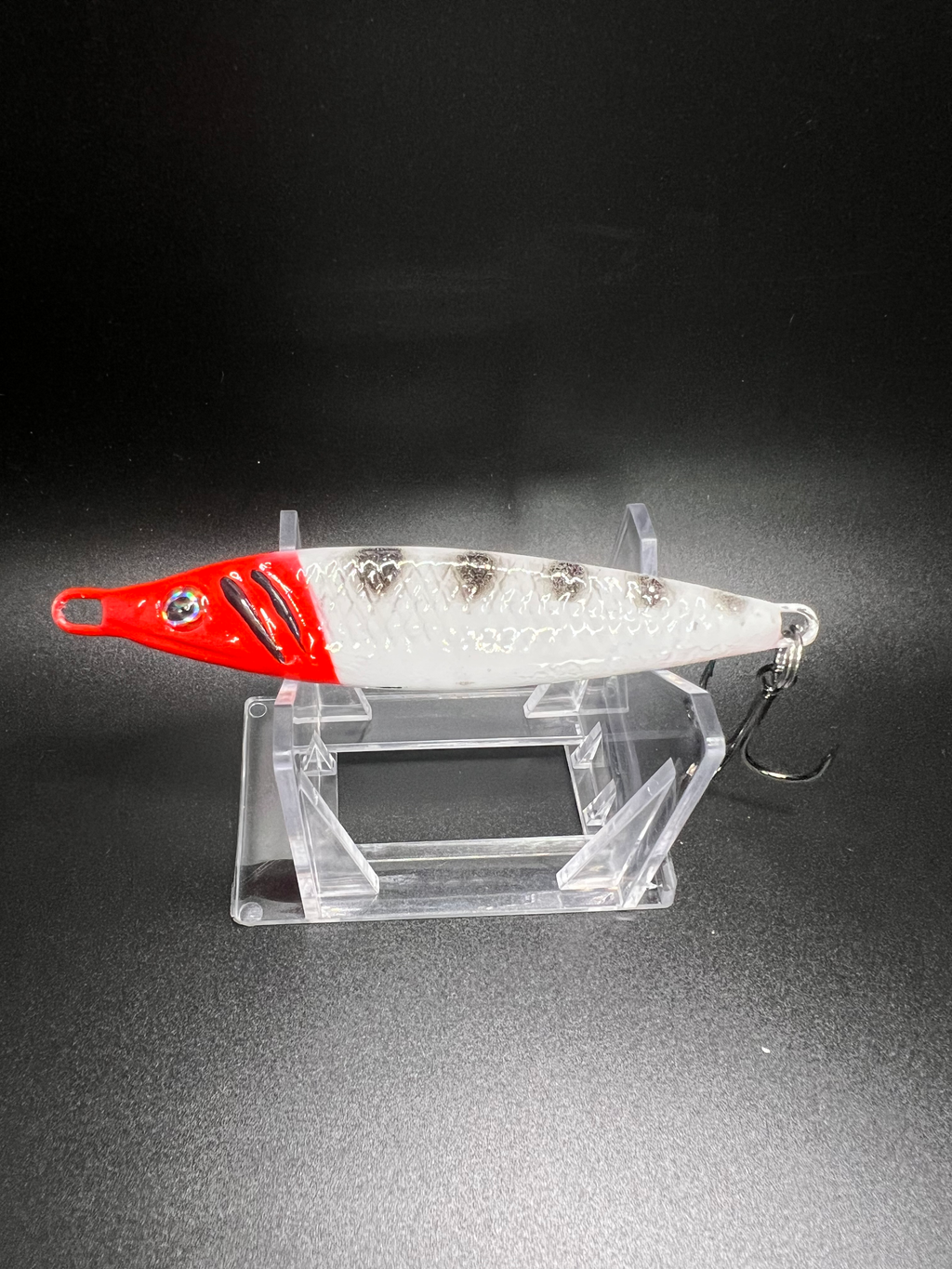 Squid Row jigging spoon 2 oz, red-and-white body with treble hook
