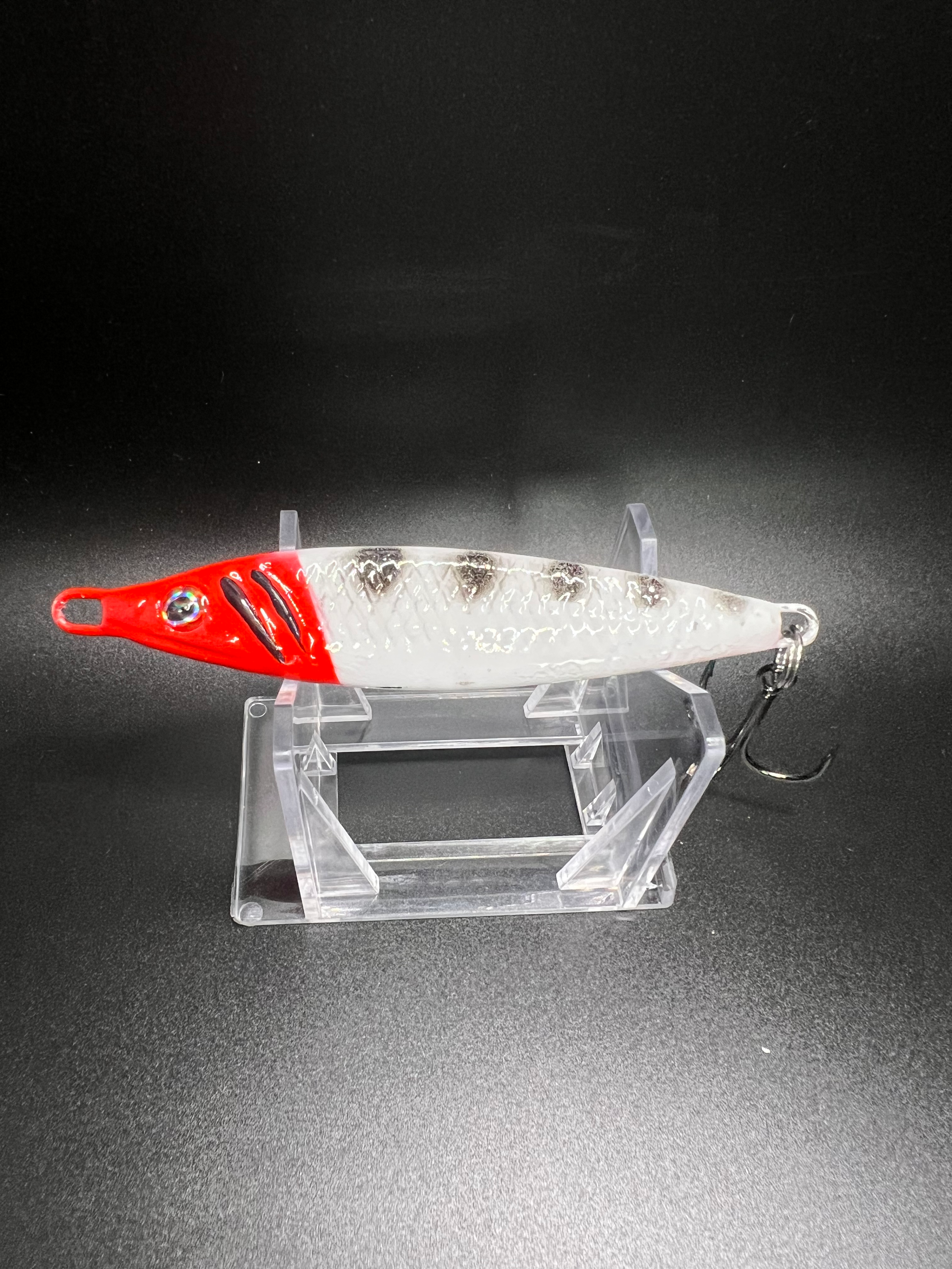 Squid Row jigging spoon 2 oz, red-and-white body with treble hook