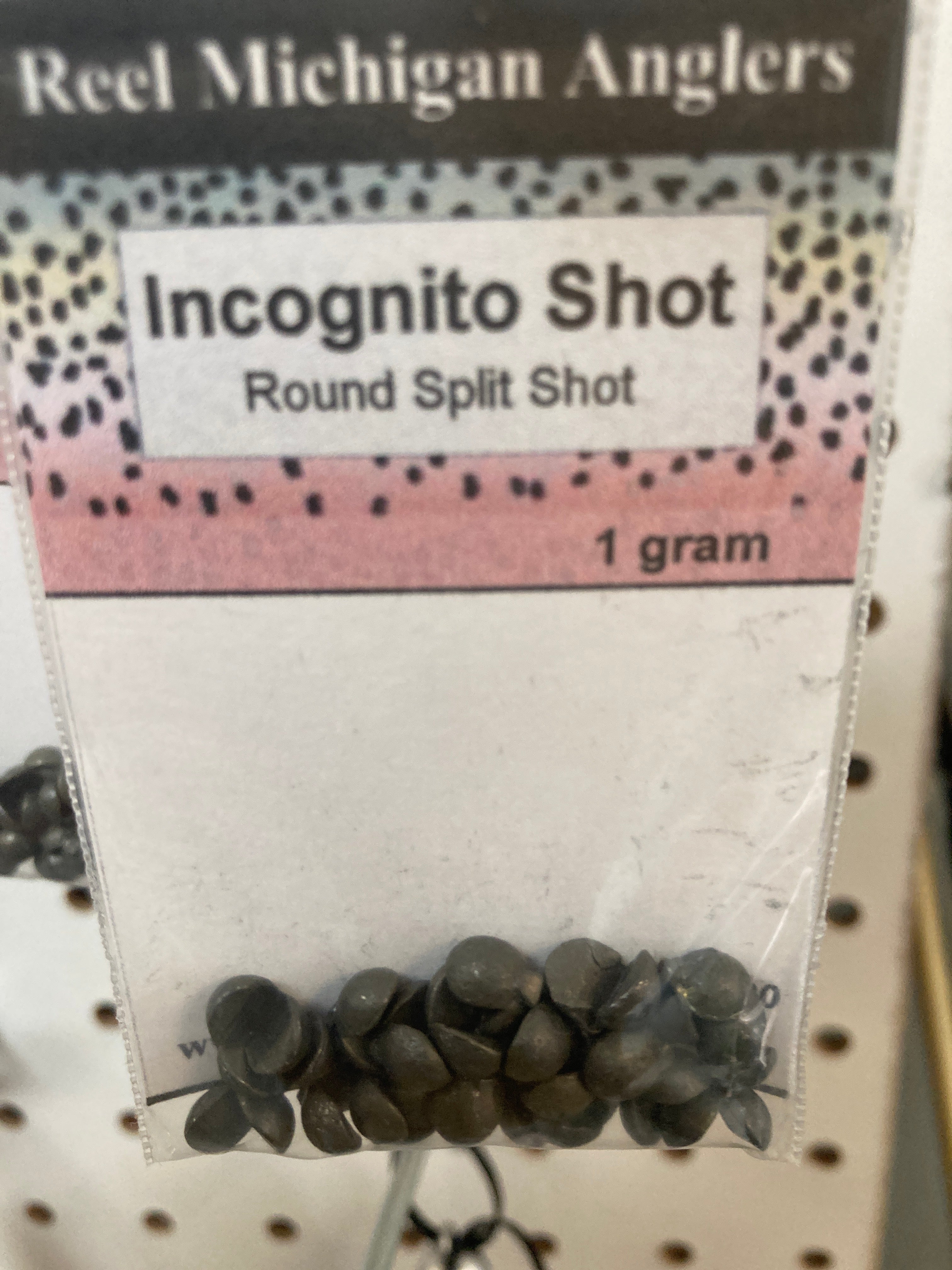 Fishing split shot sinkers, dark gray round shot pack labeled 1 gram