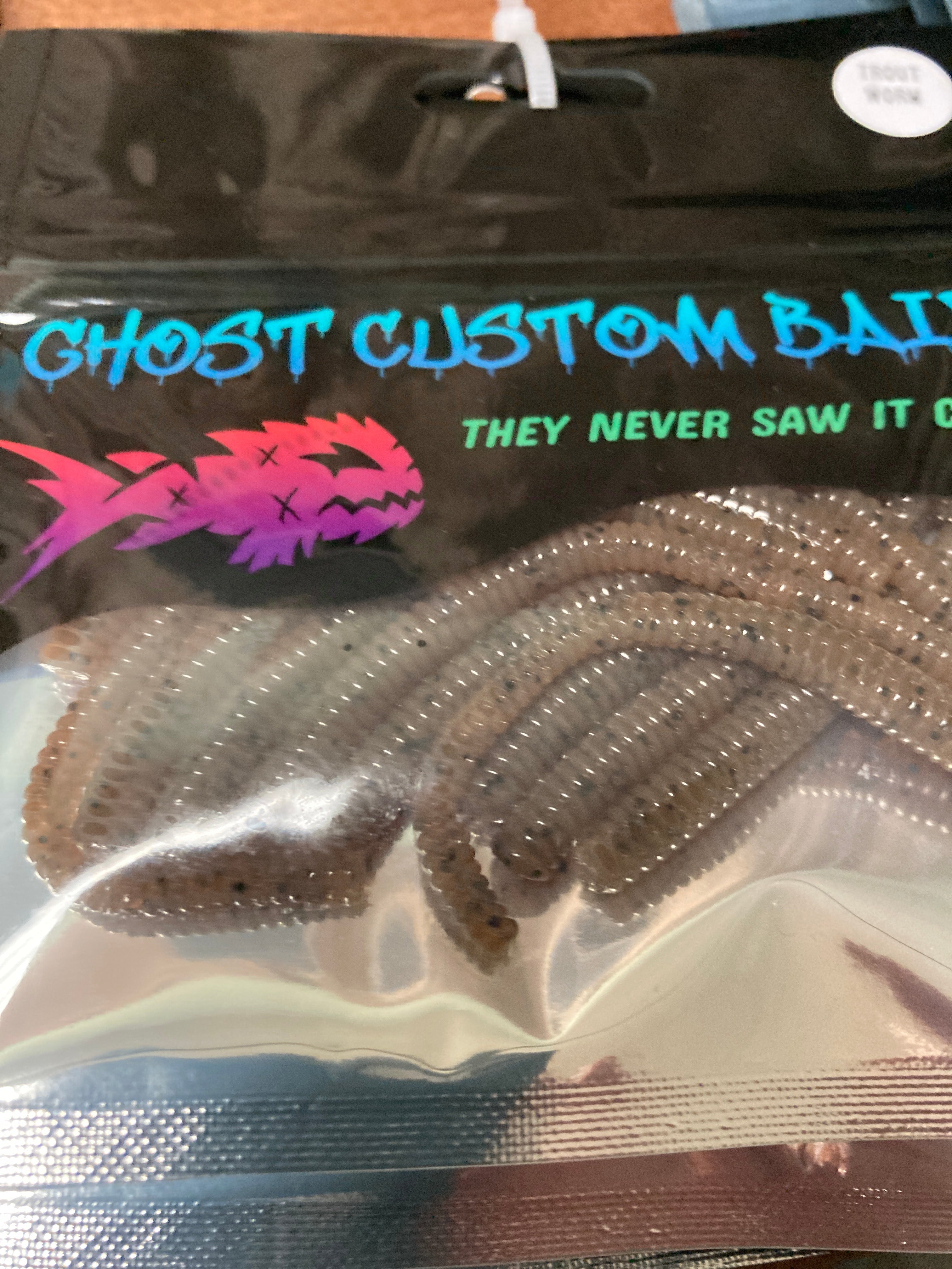 Brown custom worm bait with segmented ridges, shown bundled in clear bag