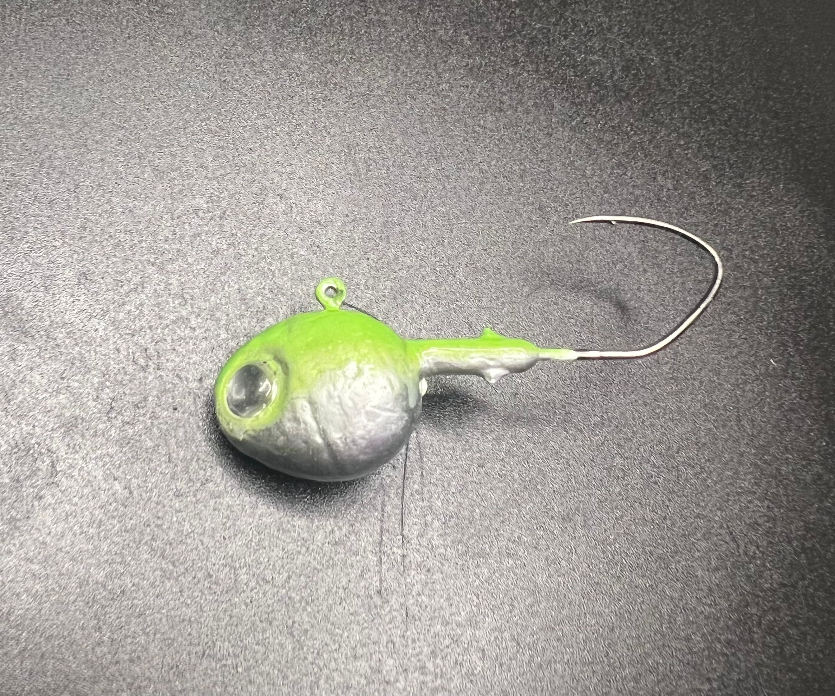 UV walleye jig, green glow head and silver body, weedless hook